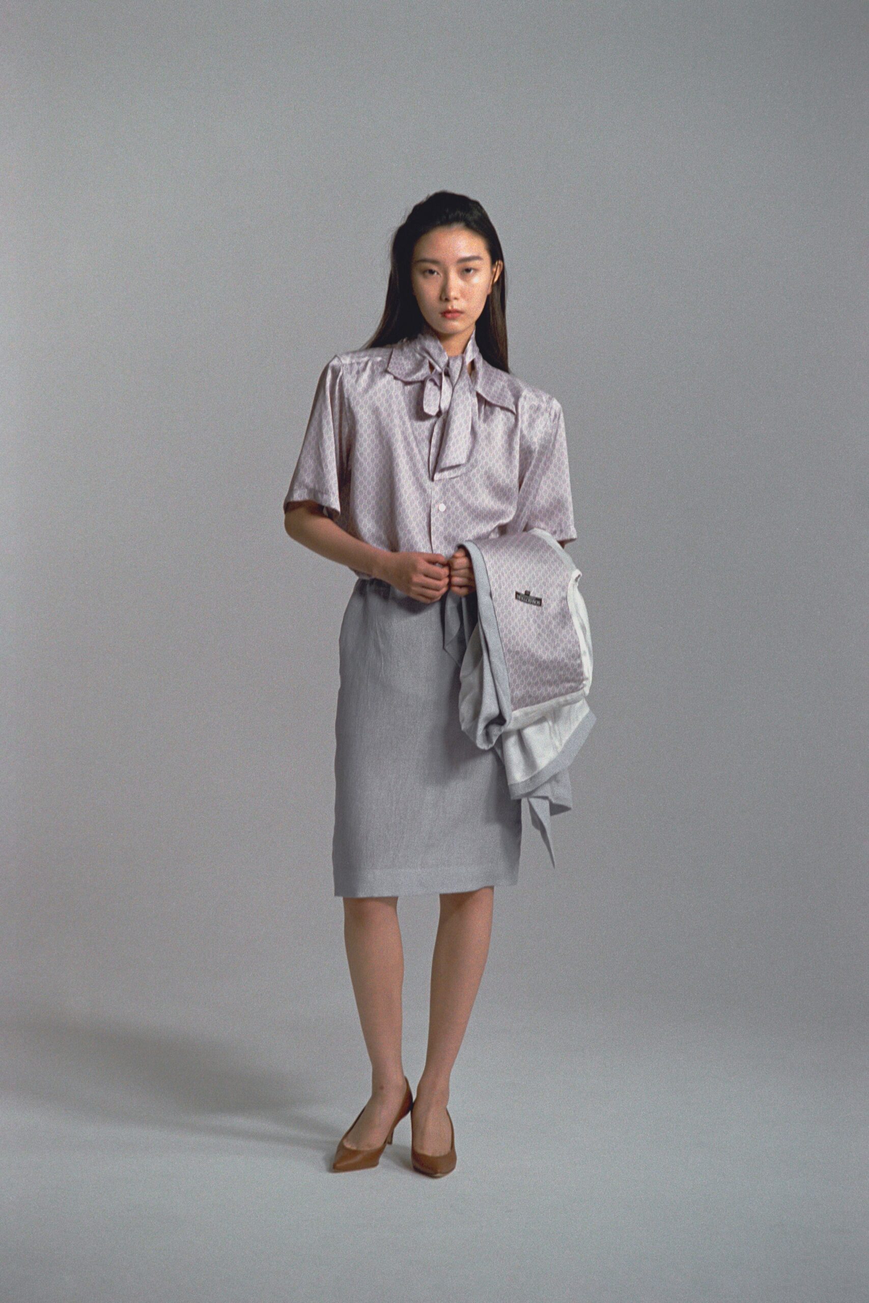 white polka-dot blouse gray pencil skirt