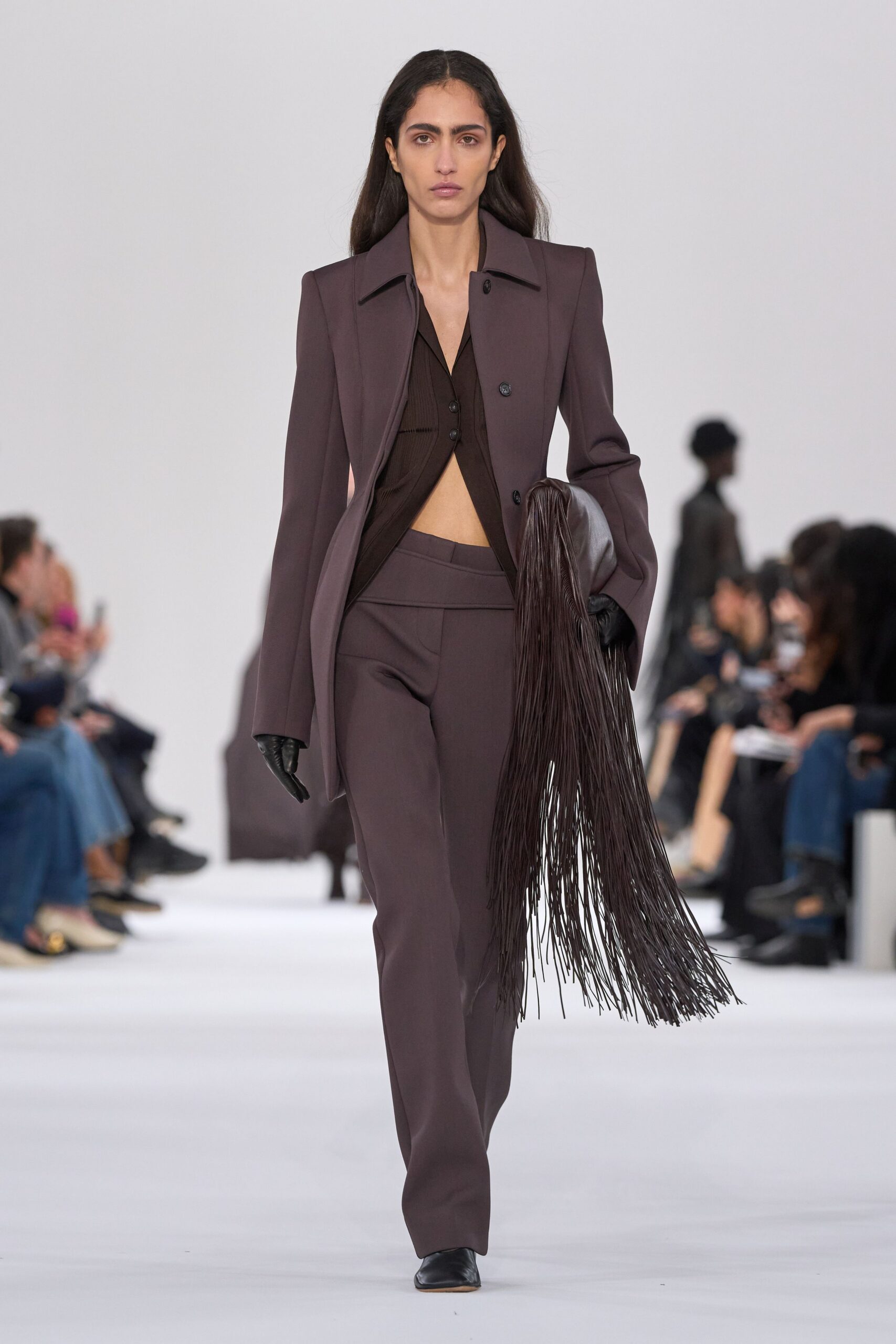 brown tailored suit with fringe bag