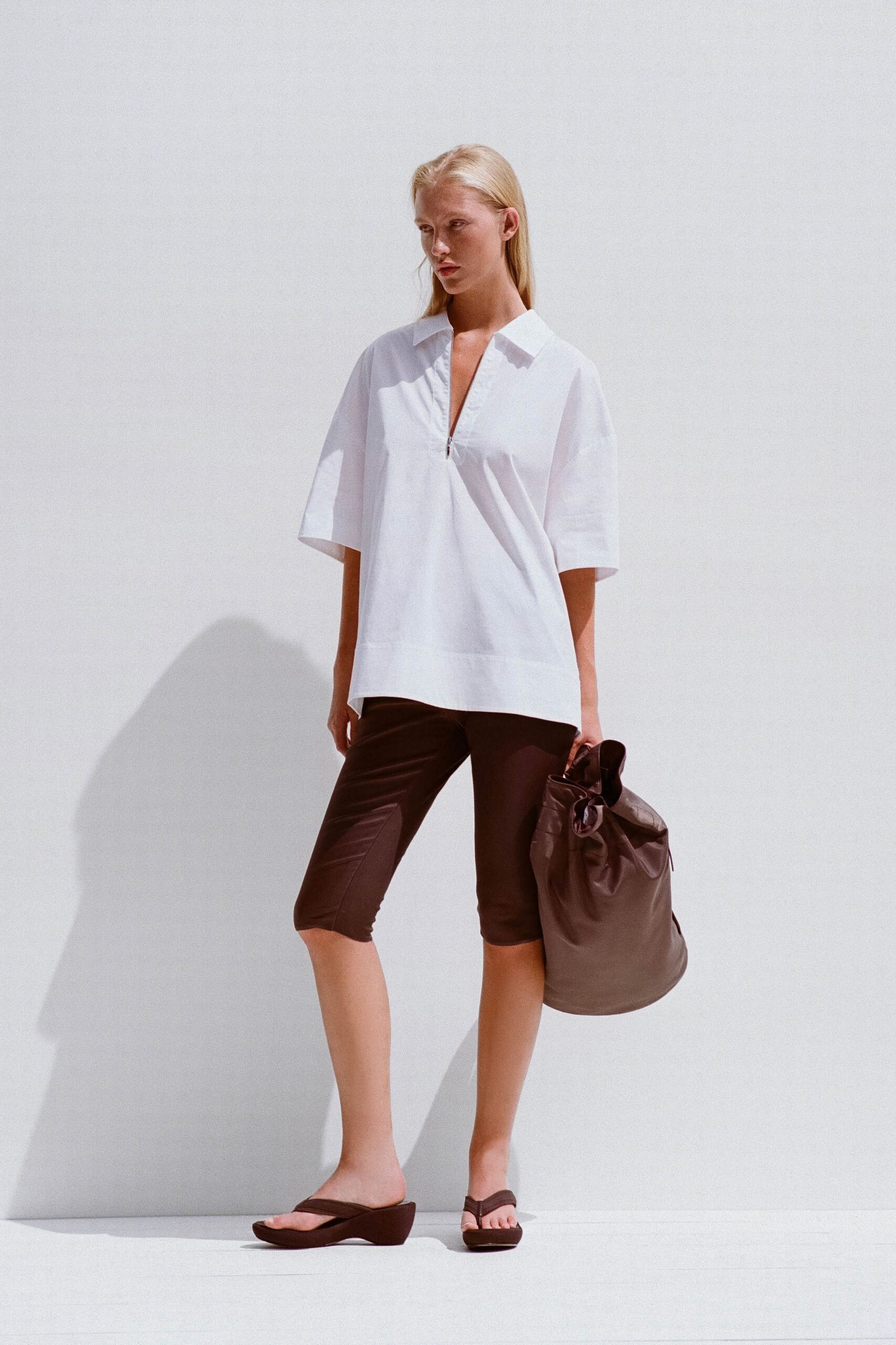 white relaxed shirt with brown shorts