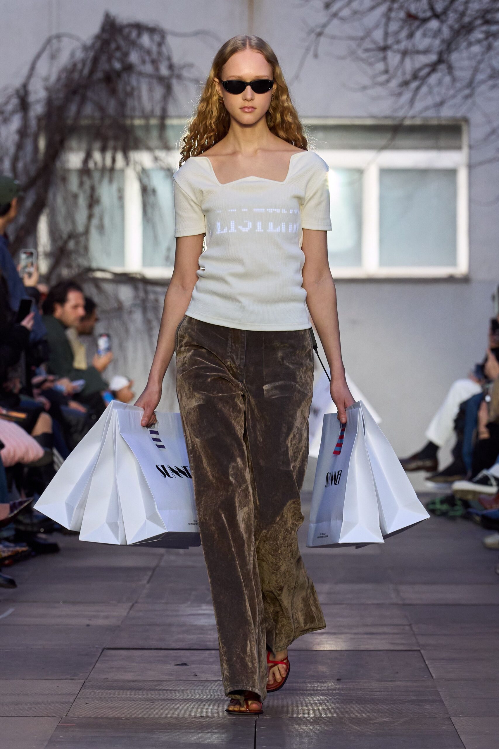 fitted white top and relaxed brown pants
