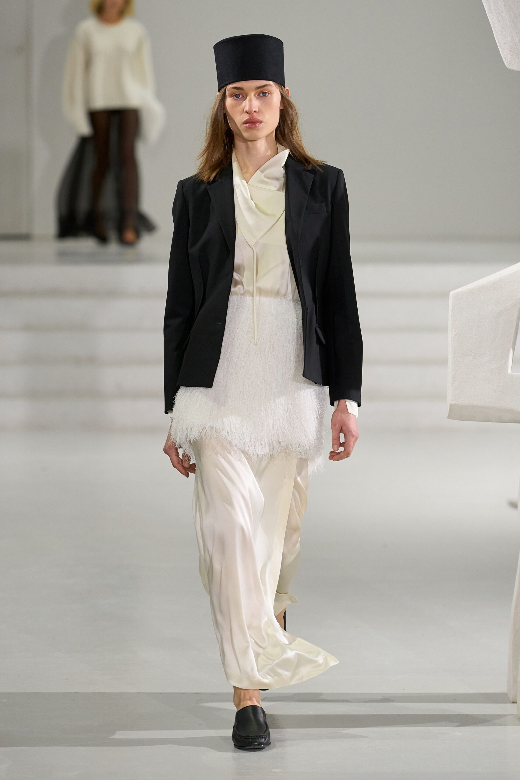 black blazer white top fringed skirt
