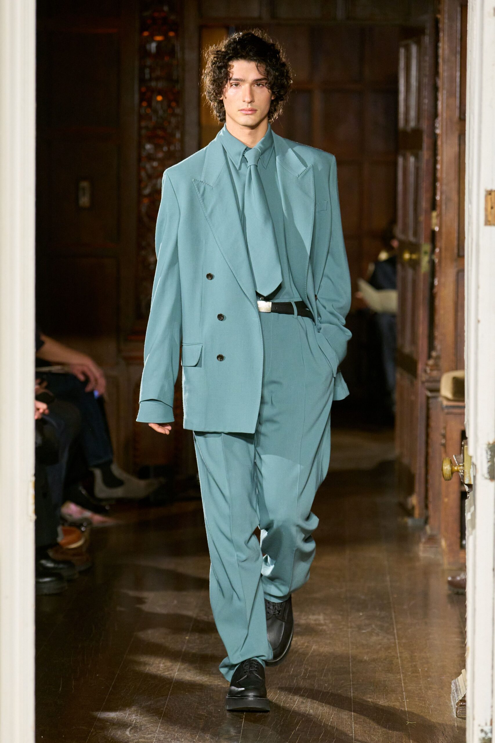 teal tailored suit with black shoes