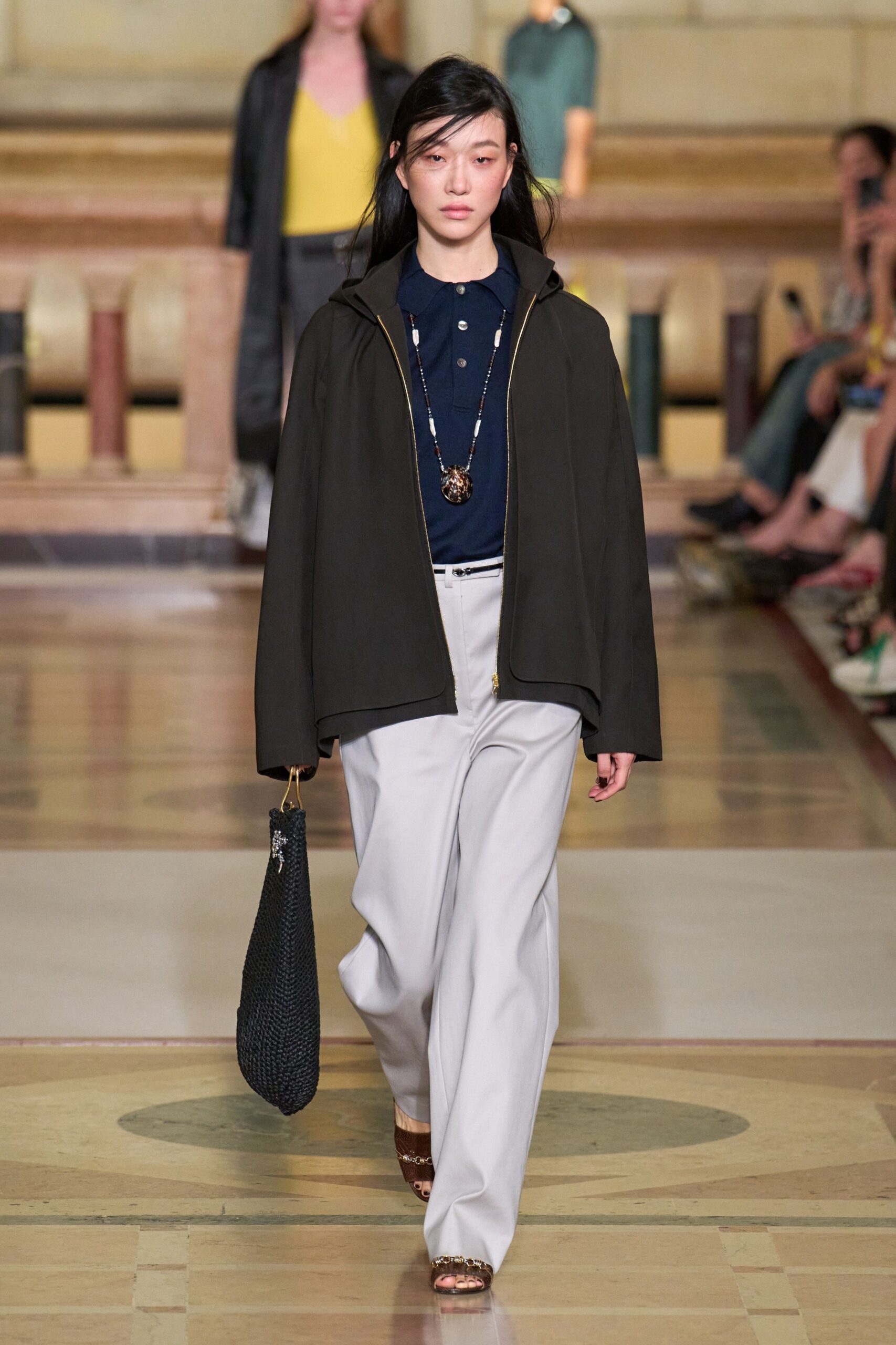 black jacket navy shirt white pants