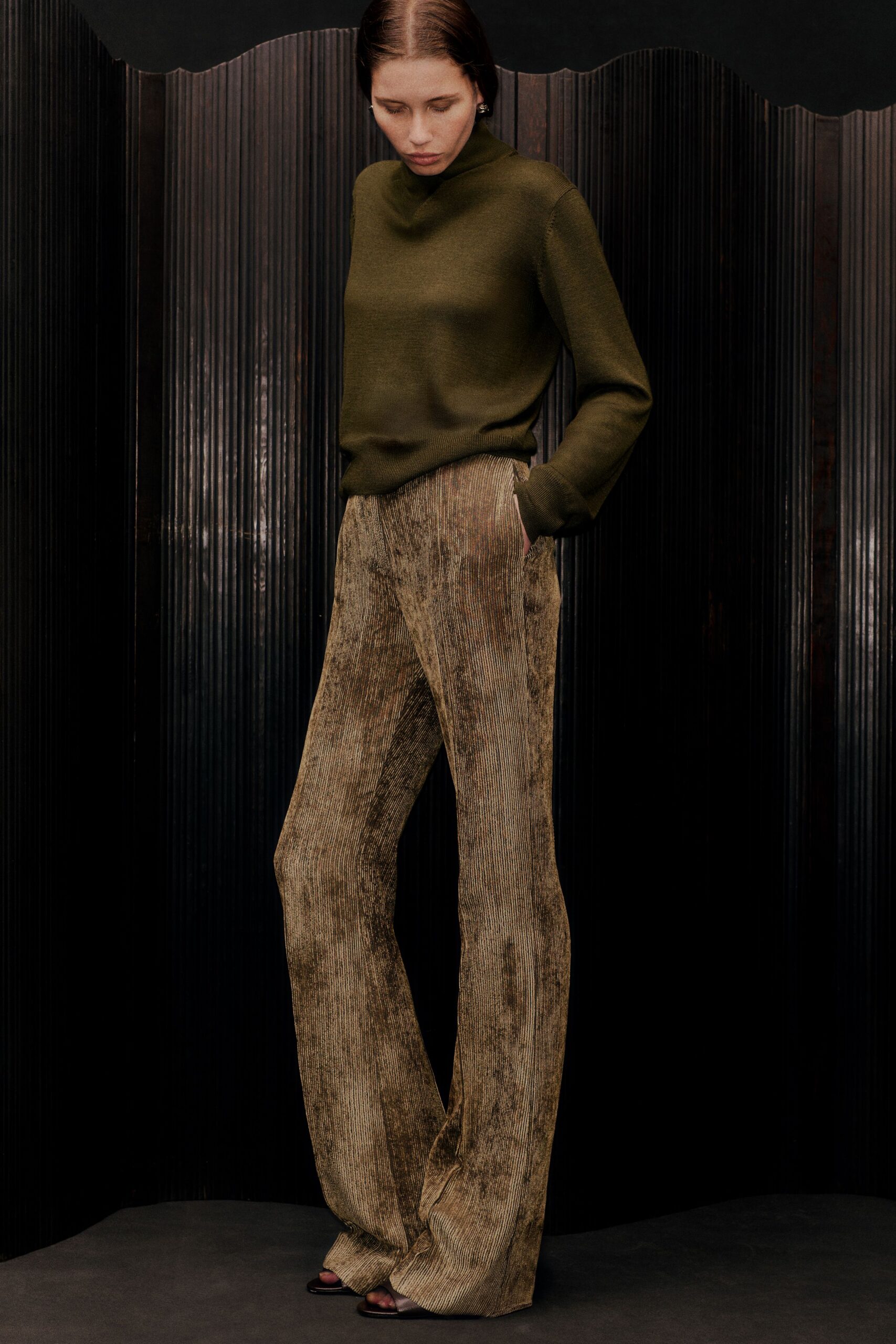 green fitted top with brown pants