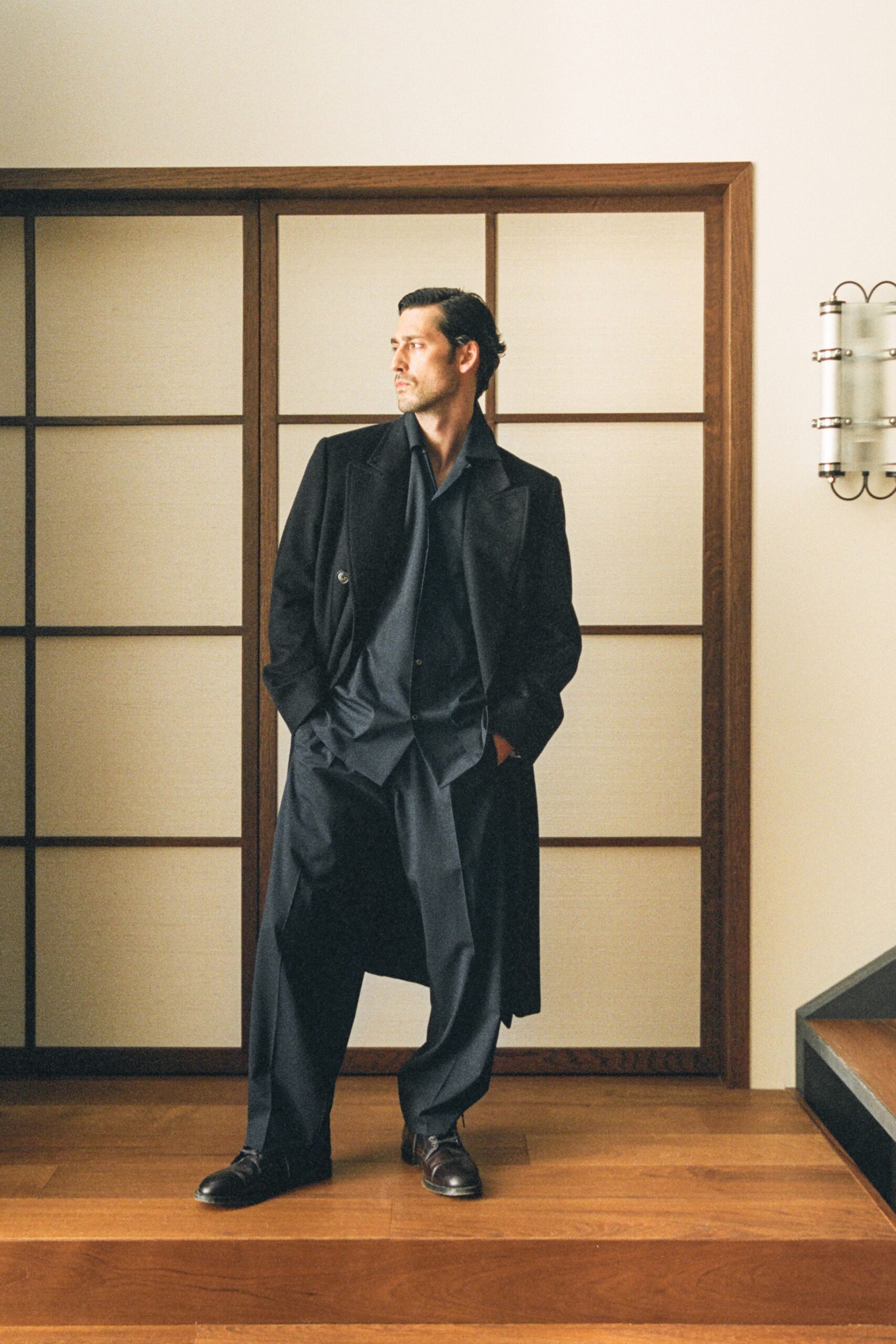 black tailored coat with relaxed pants