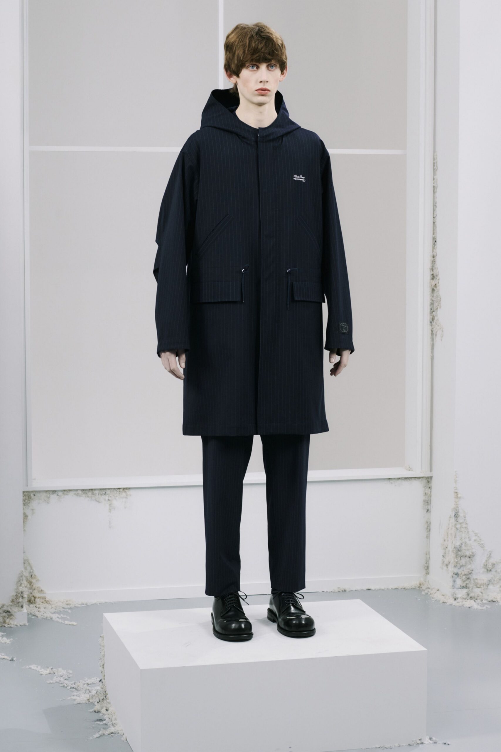 navy coat with hood and tailored pants