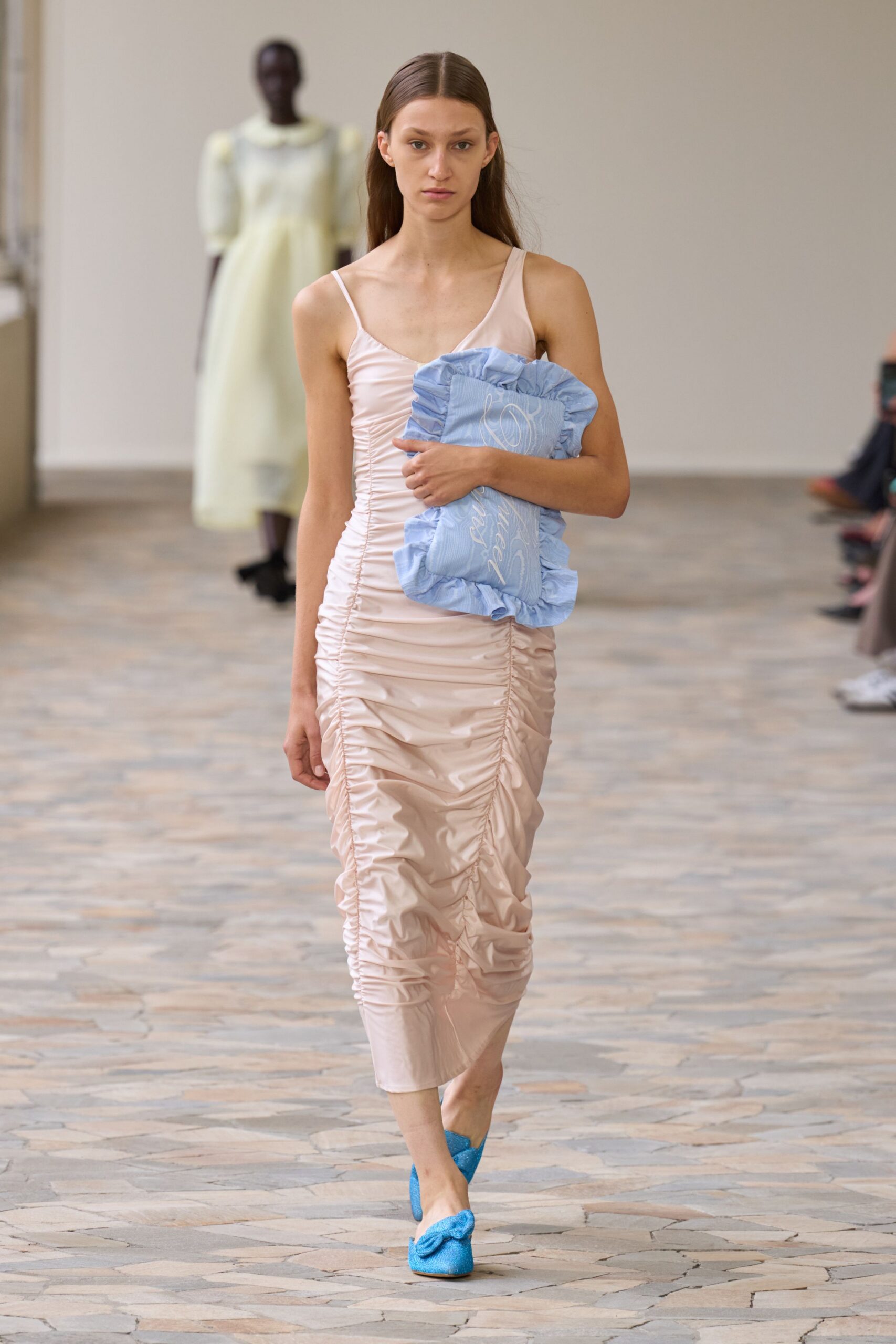 pink ruched midi dress with blue accessories