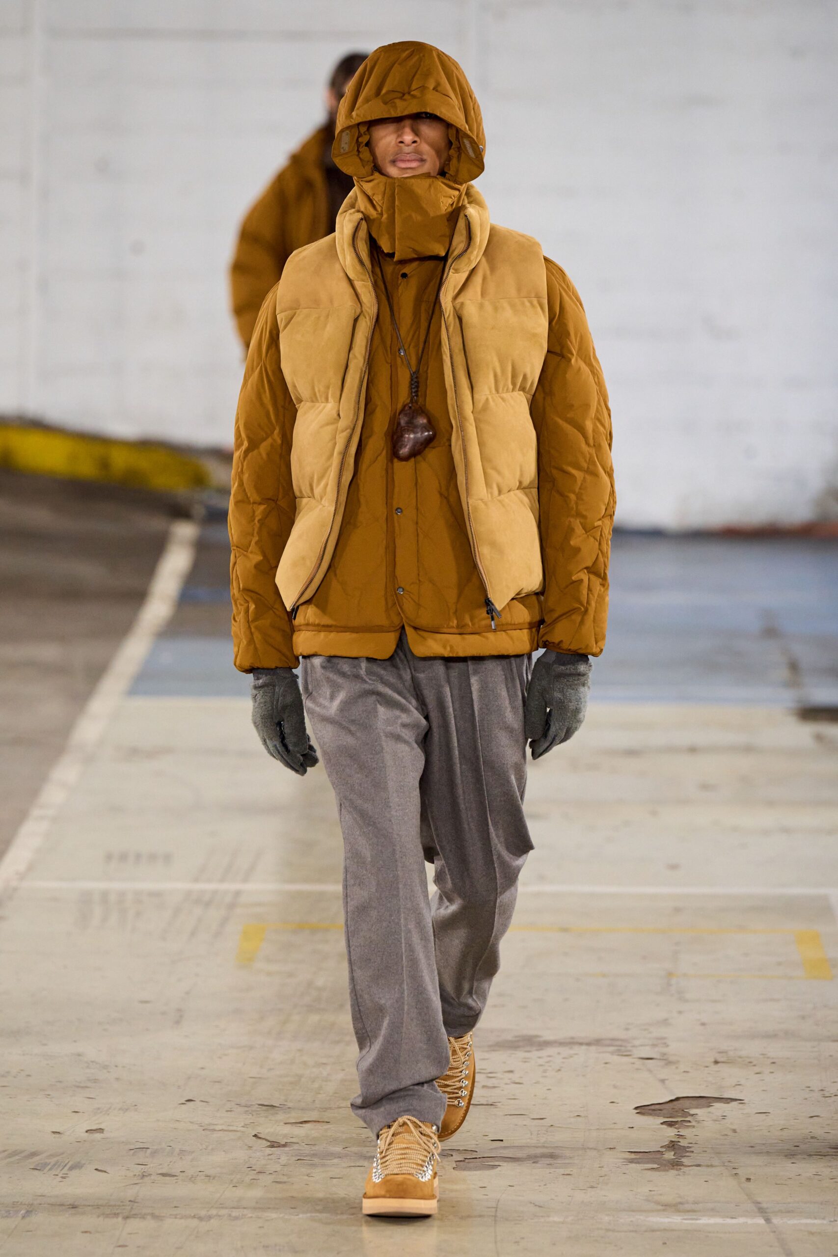 brown quilted jacket and gray pants