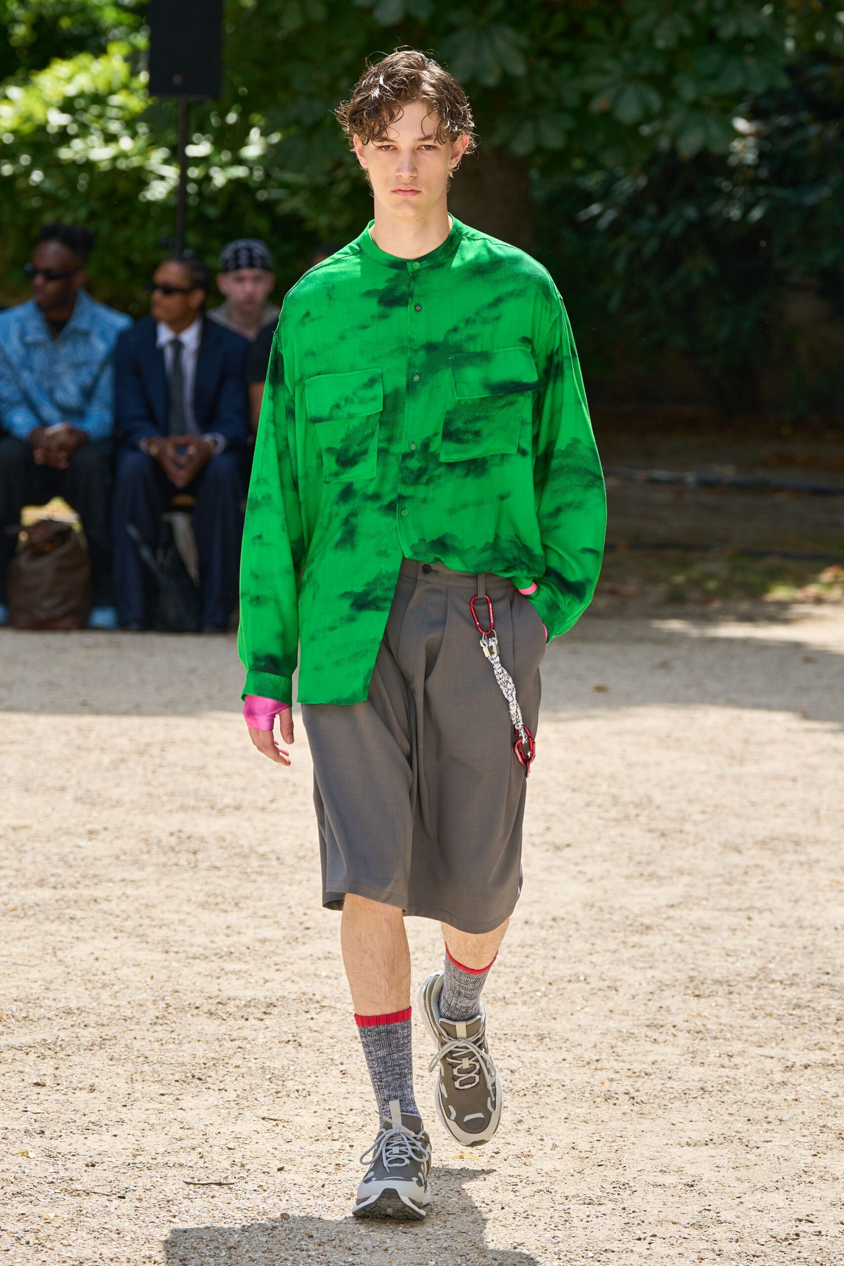 green printed shirt with gray shorts