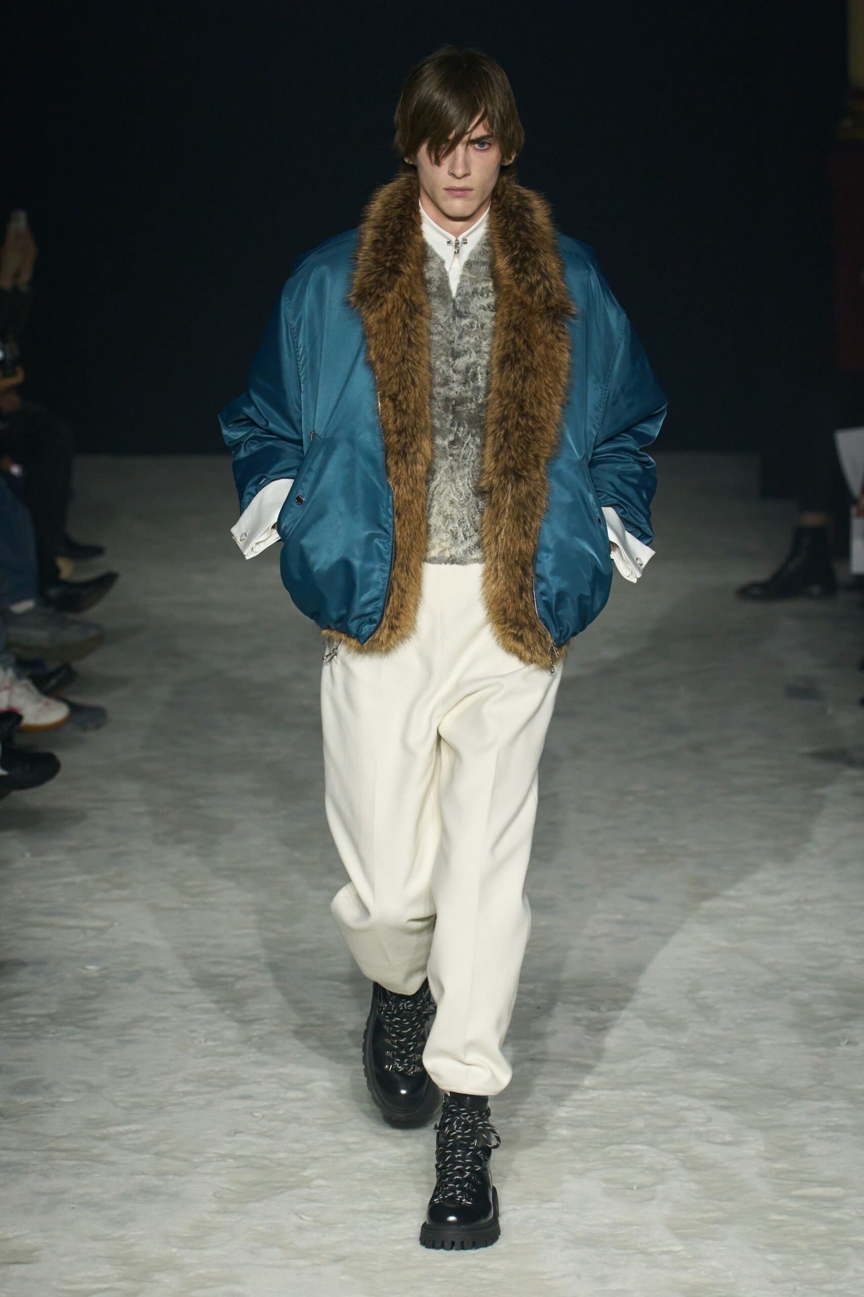 blue jacket gray sweater white pants black boots