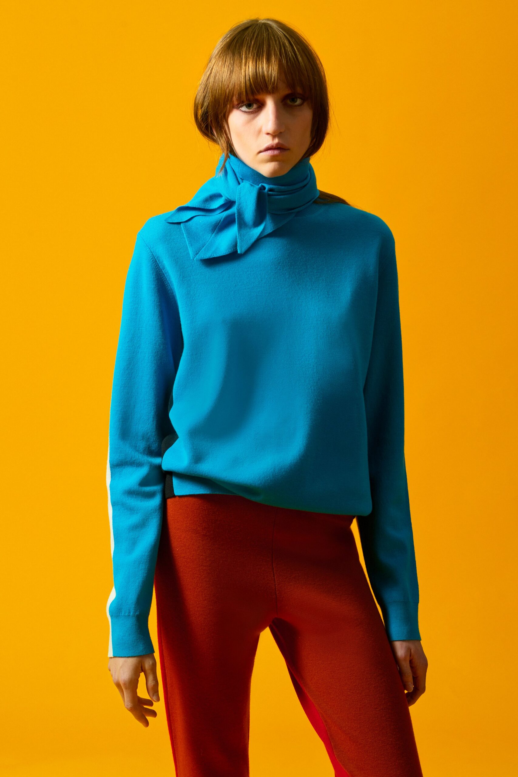 blue fitted sweater and red pants