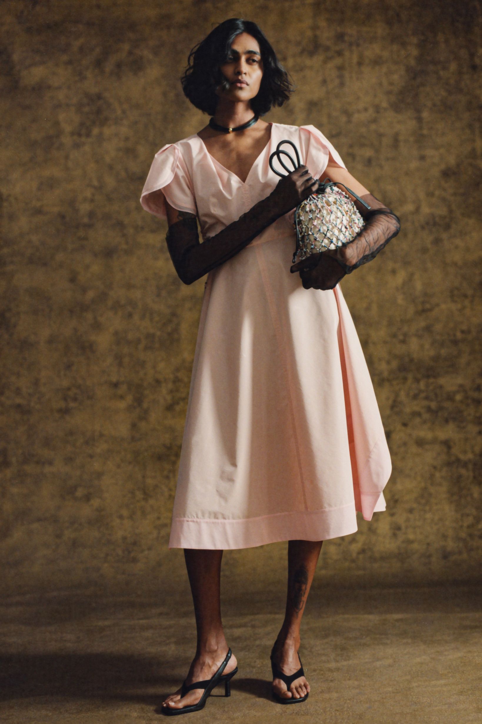 pink midi dress with beaded bag