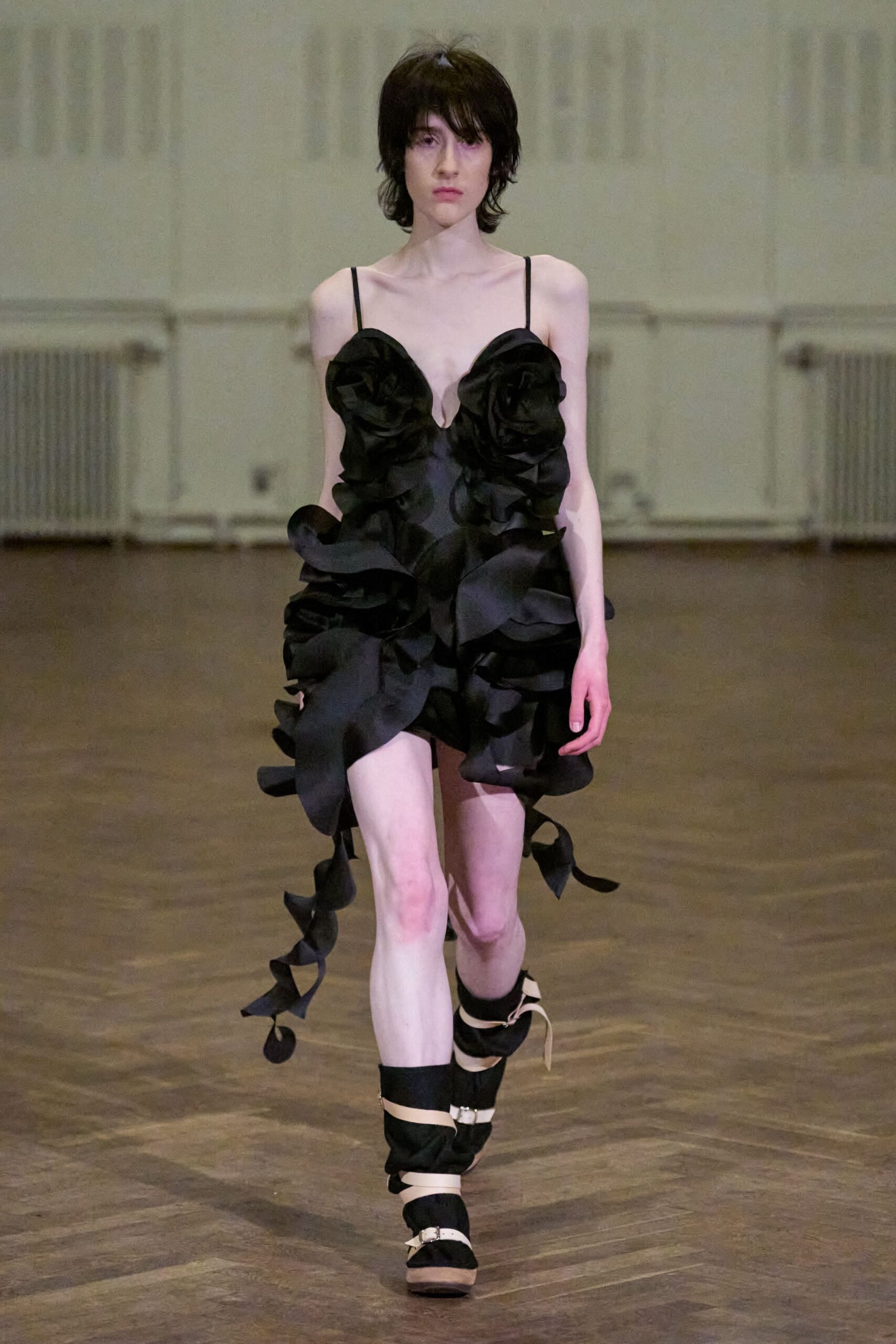 black ruffled mini dress with strappy shoes