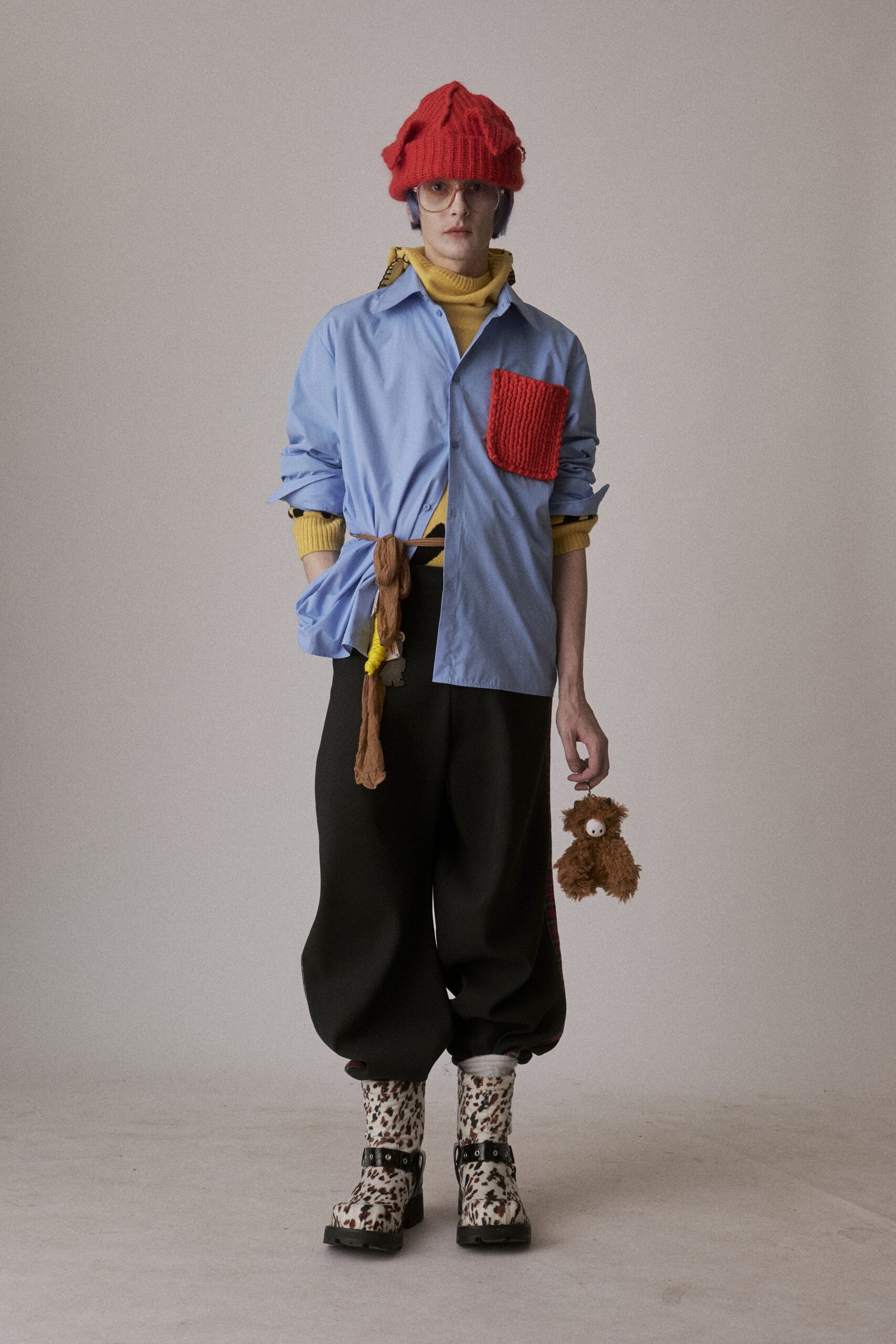 blue shirt yellow sweater black pants