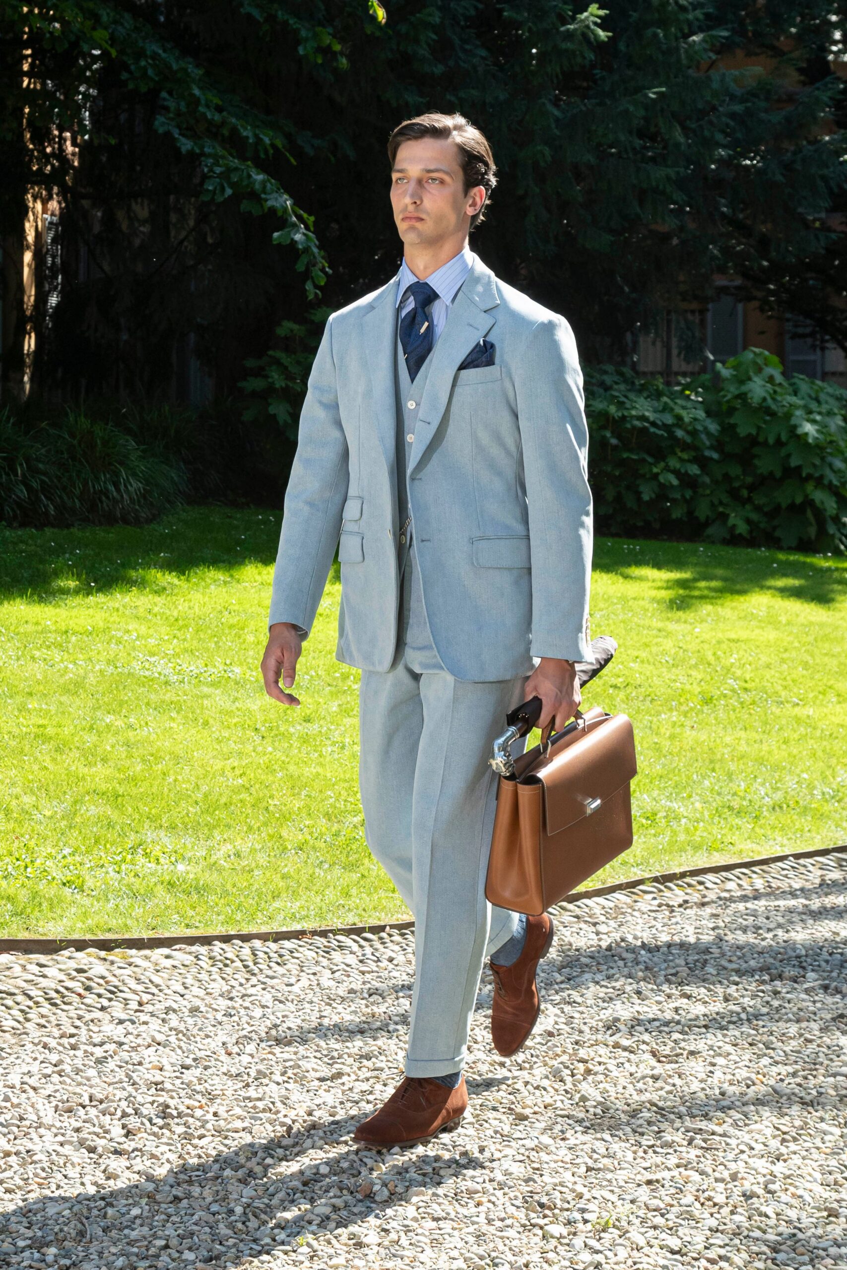 light blue tailored suit with brown accessories