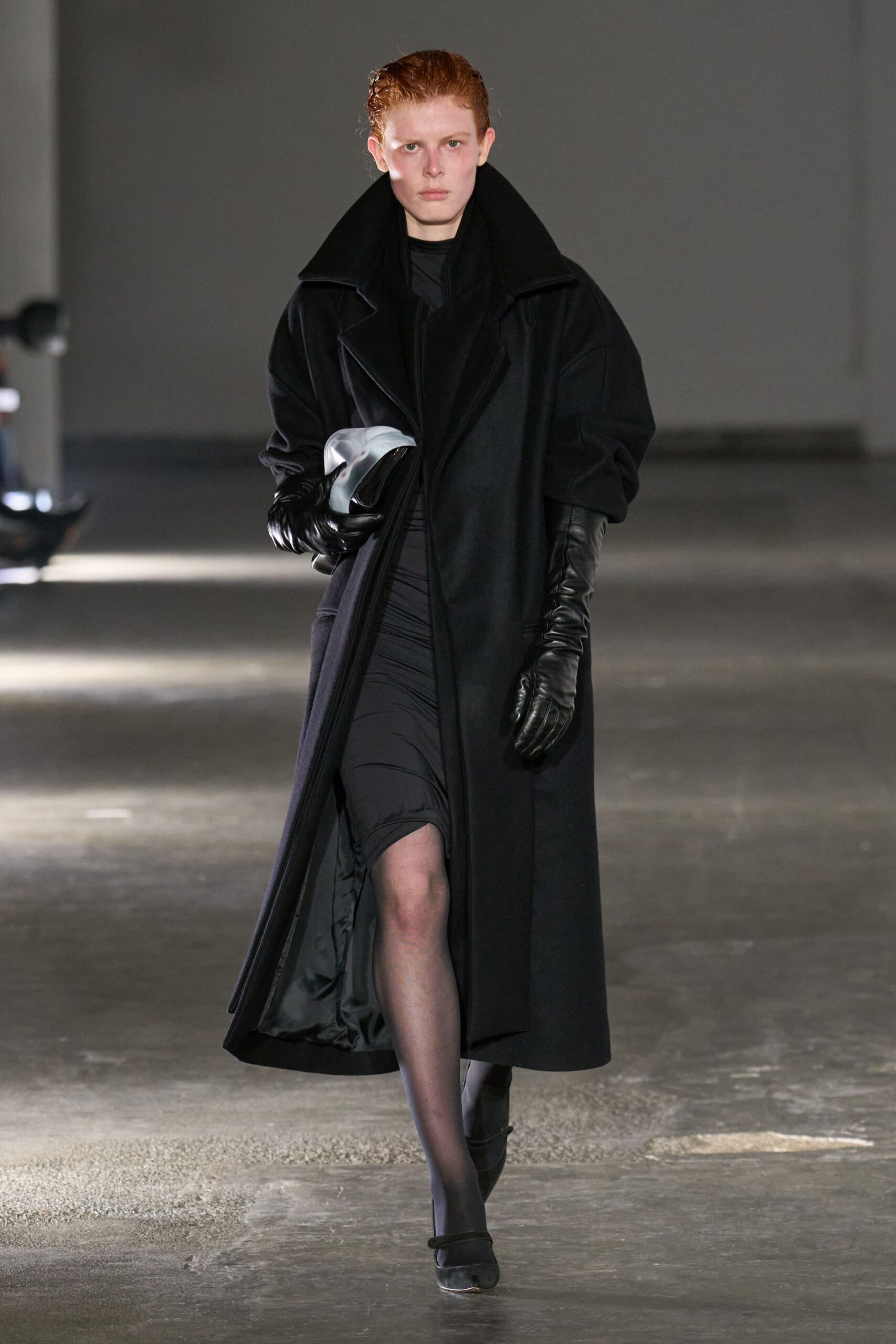 black oversized coat and fitted dress
