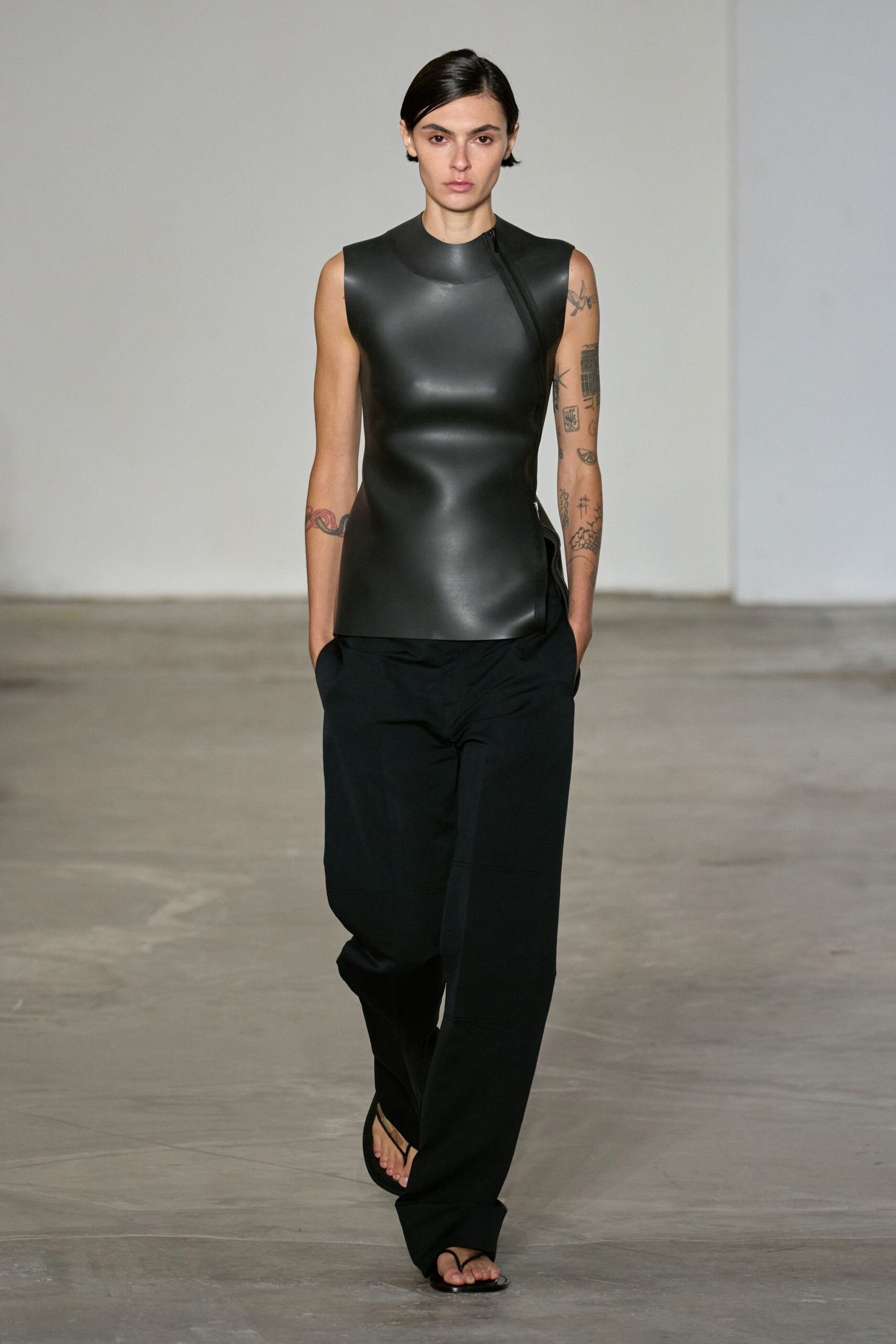 black neoprene sleeveless top and relaxed pants