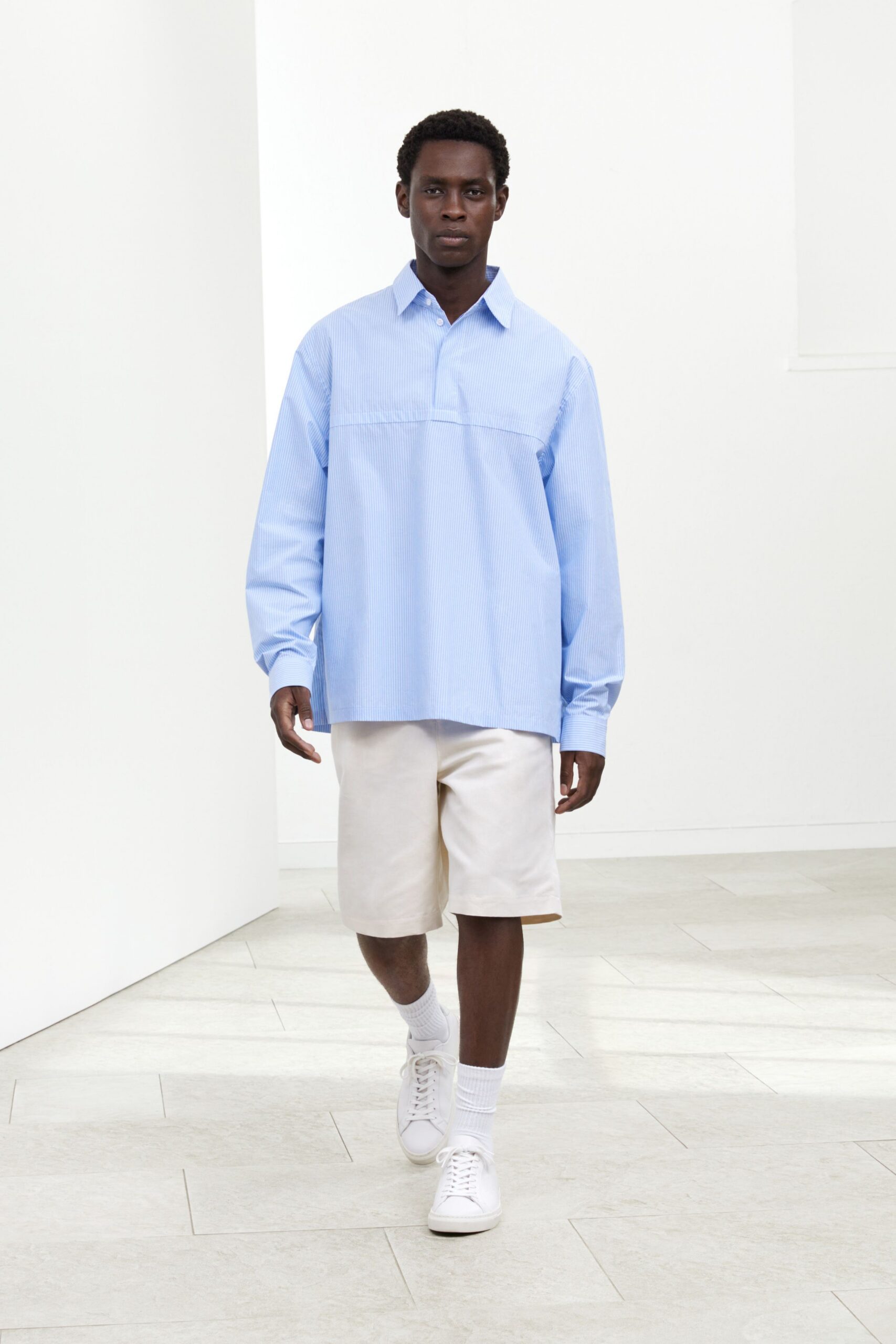 blue relaxed shirt with beige shorts