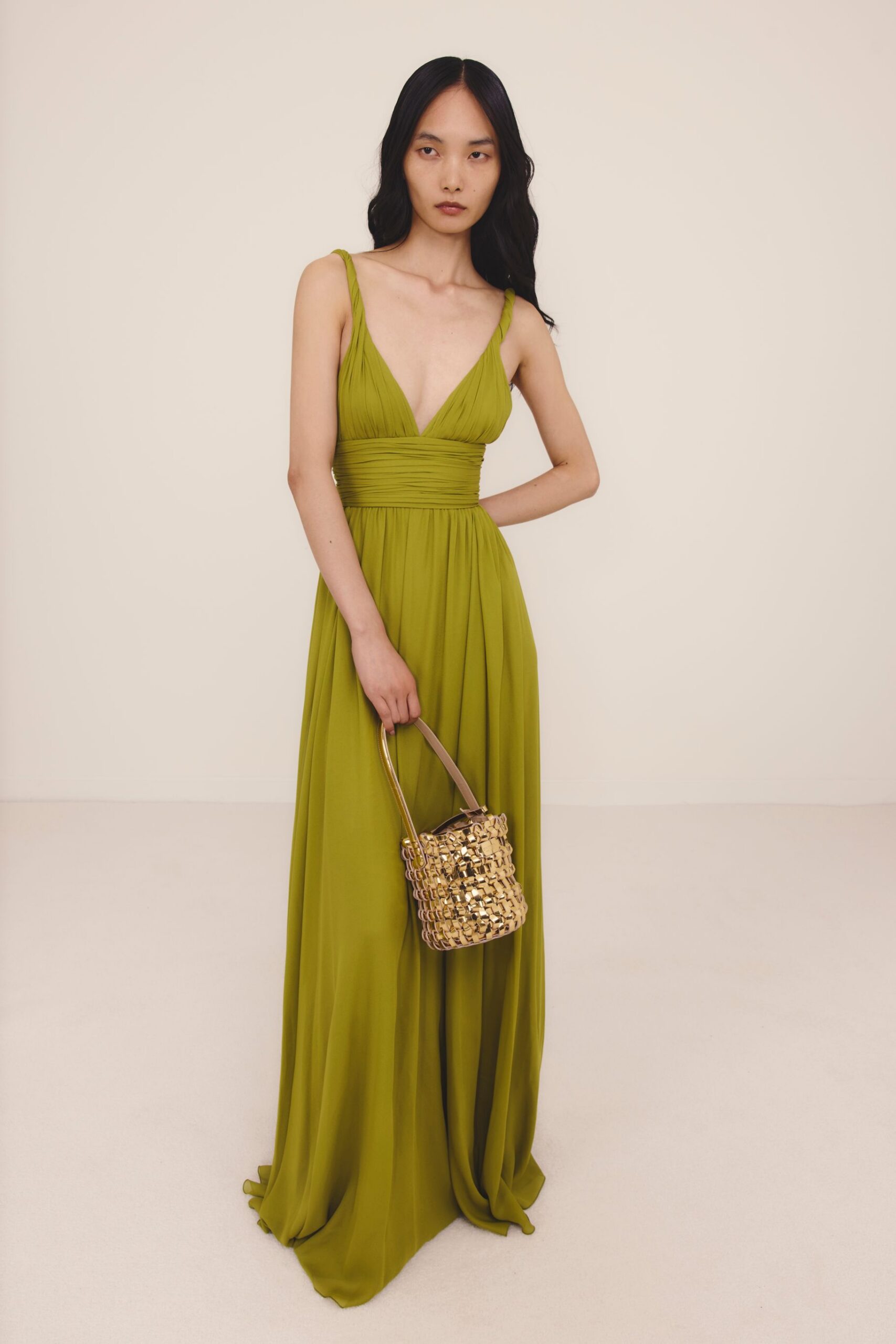 green chiffon sleeveless v-neck fitted pleated flowing gown