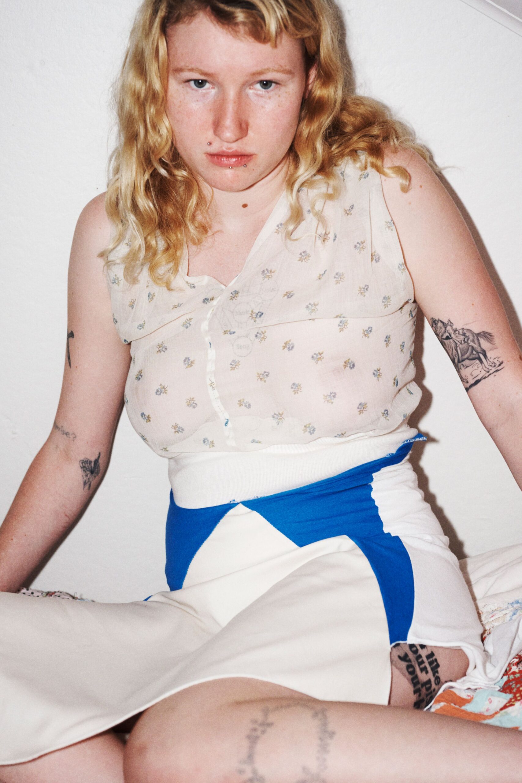 white embroidered sleeveless top and color-blocked skirt