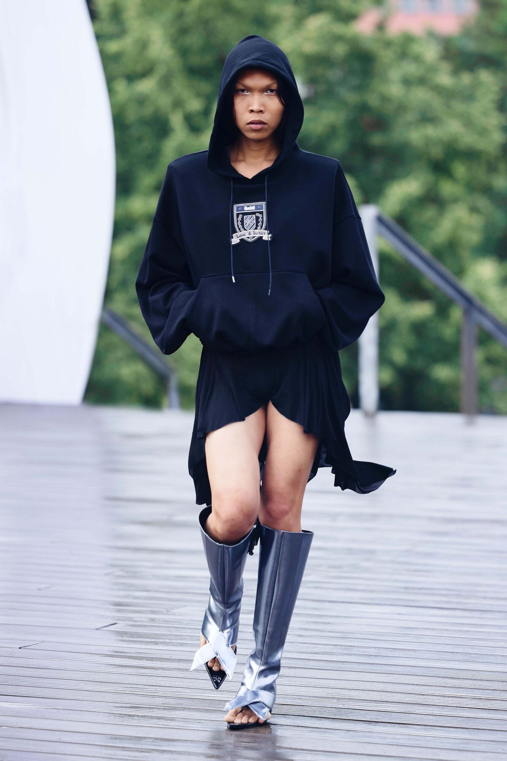 black hoodie with mini skirt and silver boots
