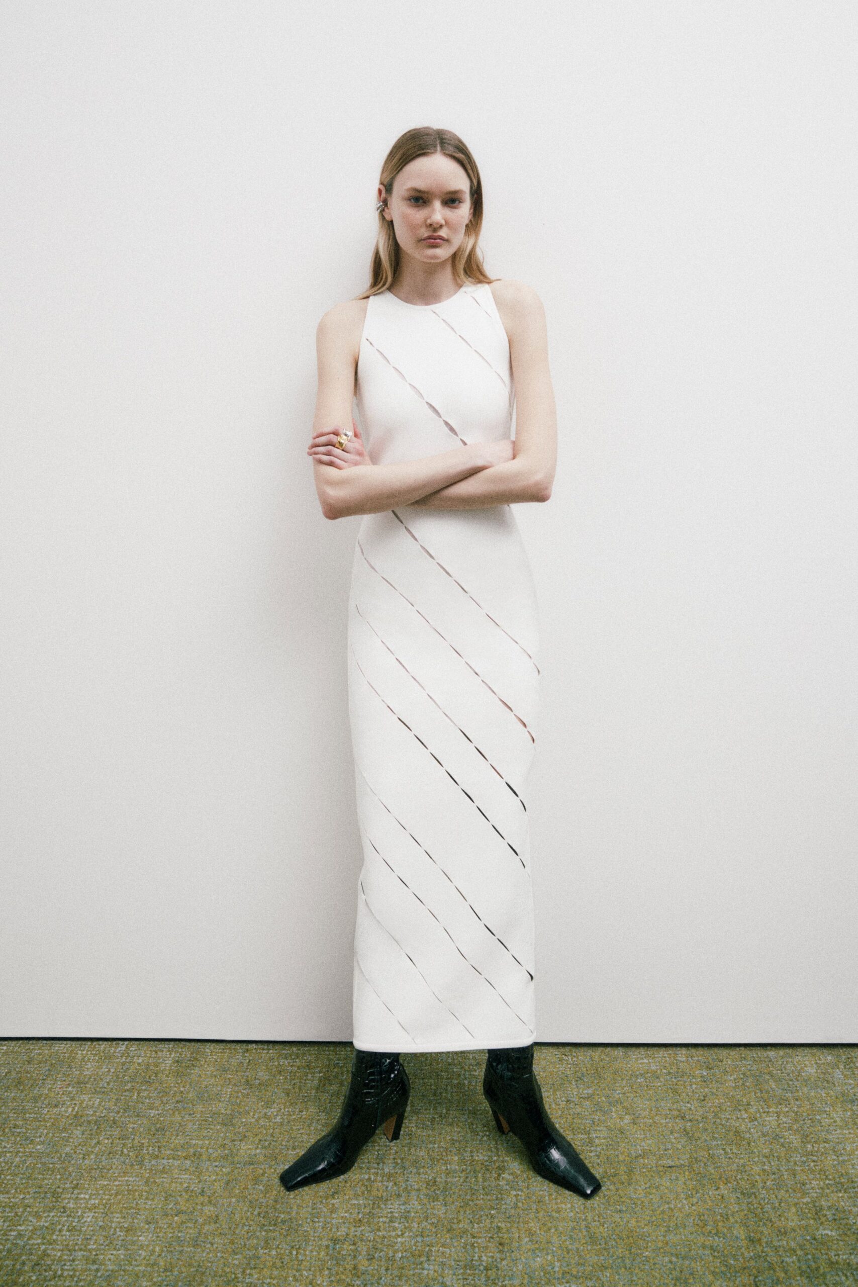 white silk sleeveless dress with black boots