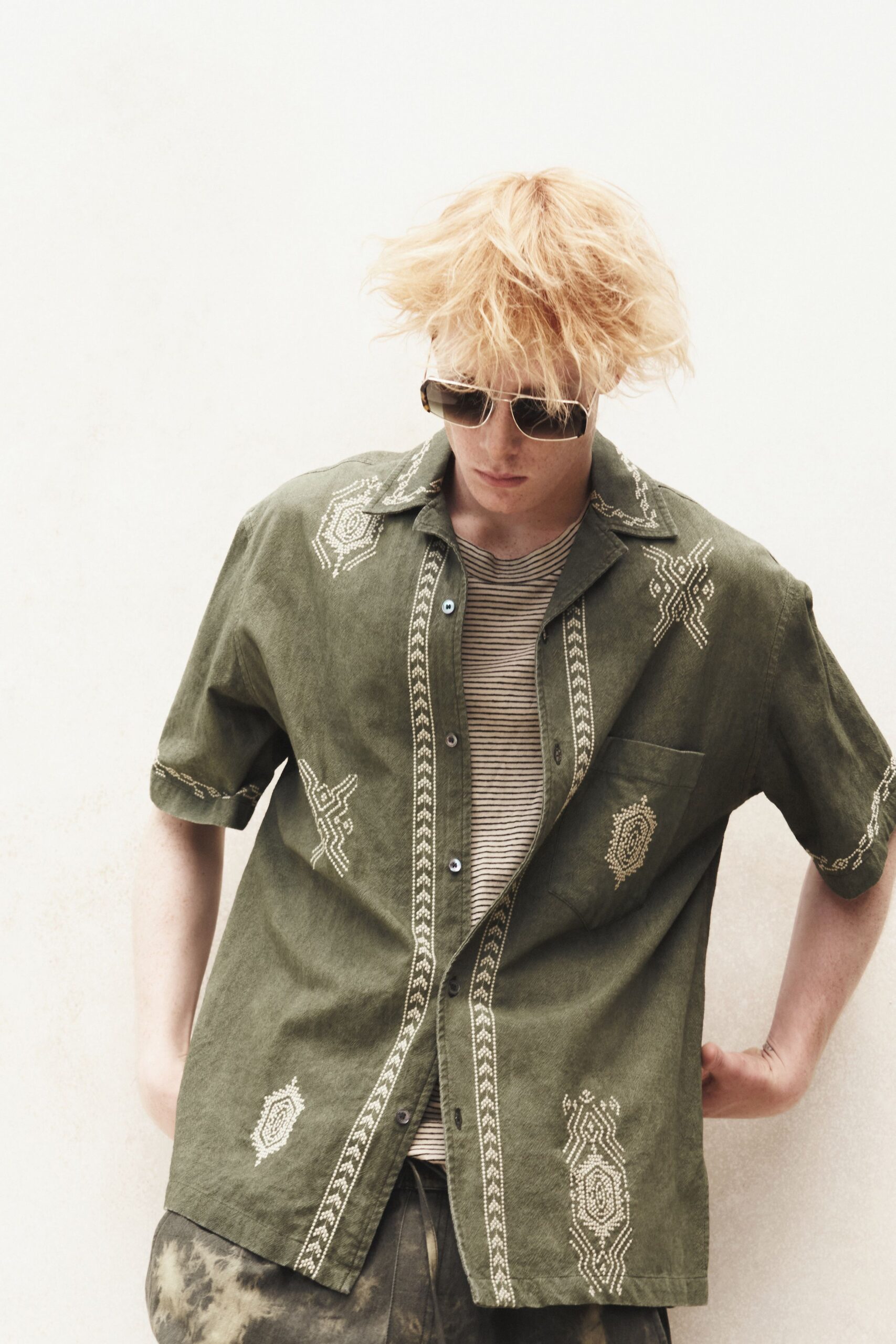green embroidered shirt with sunglasses