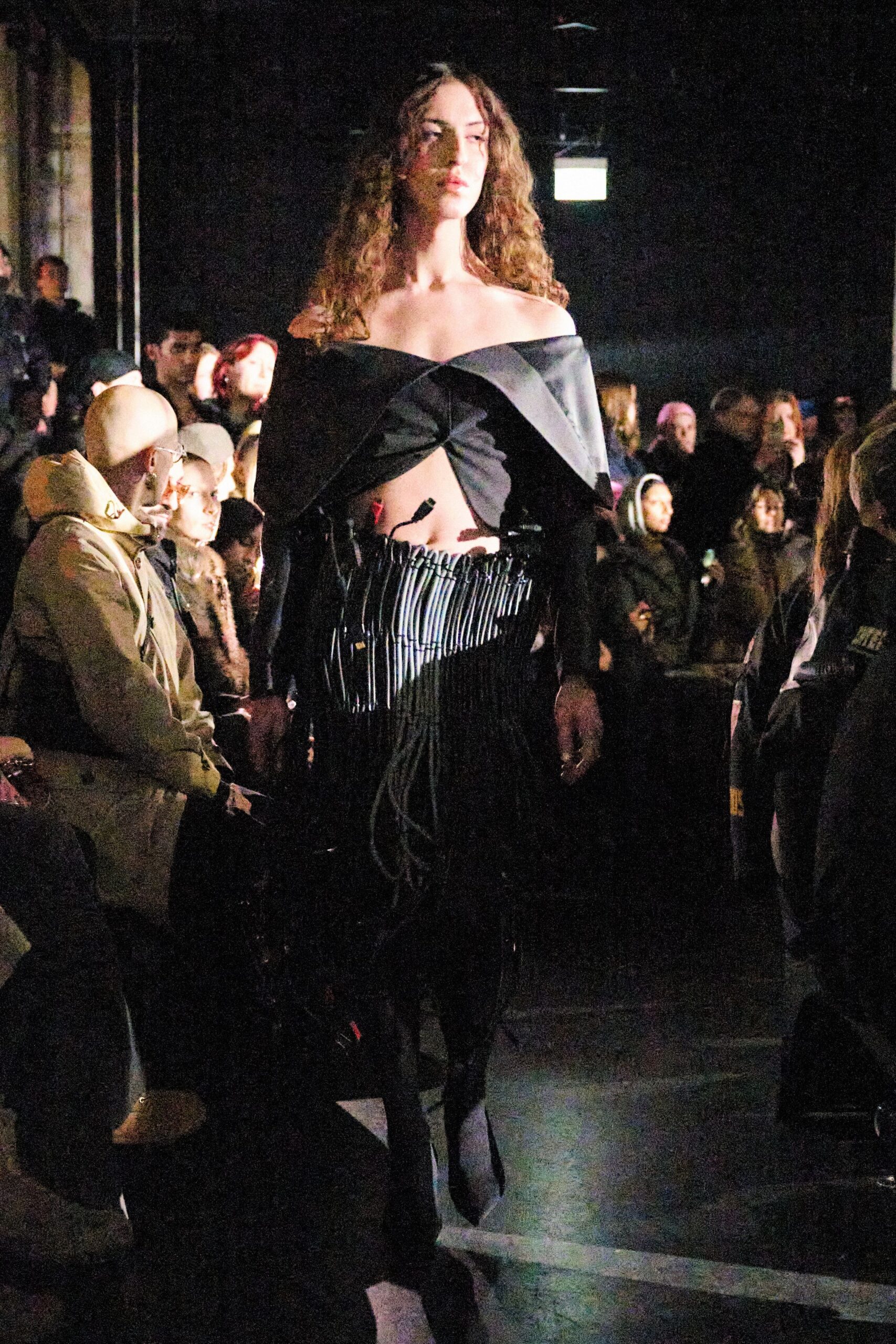 black off-shoulder top with fringed skirt
