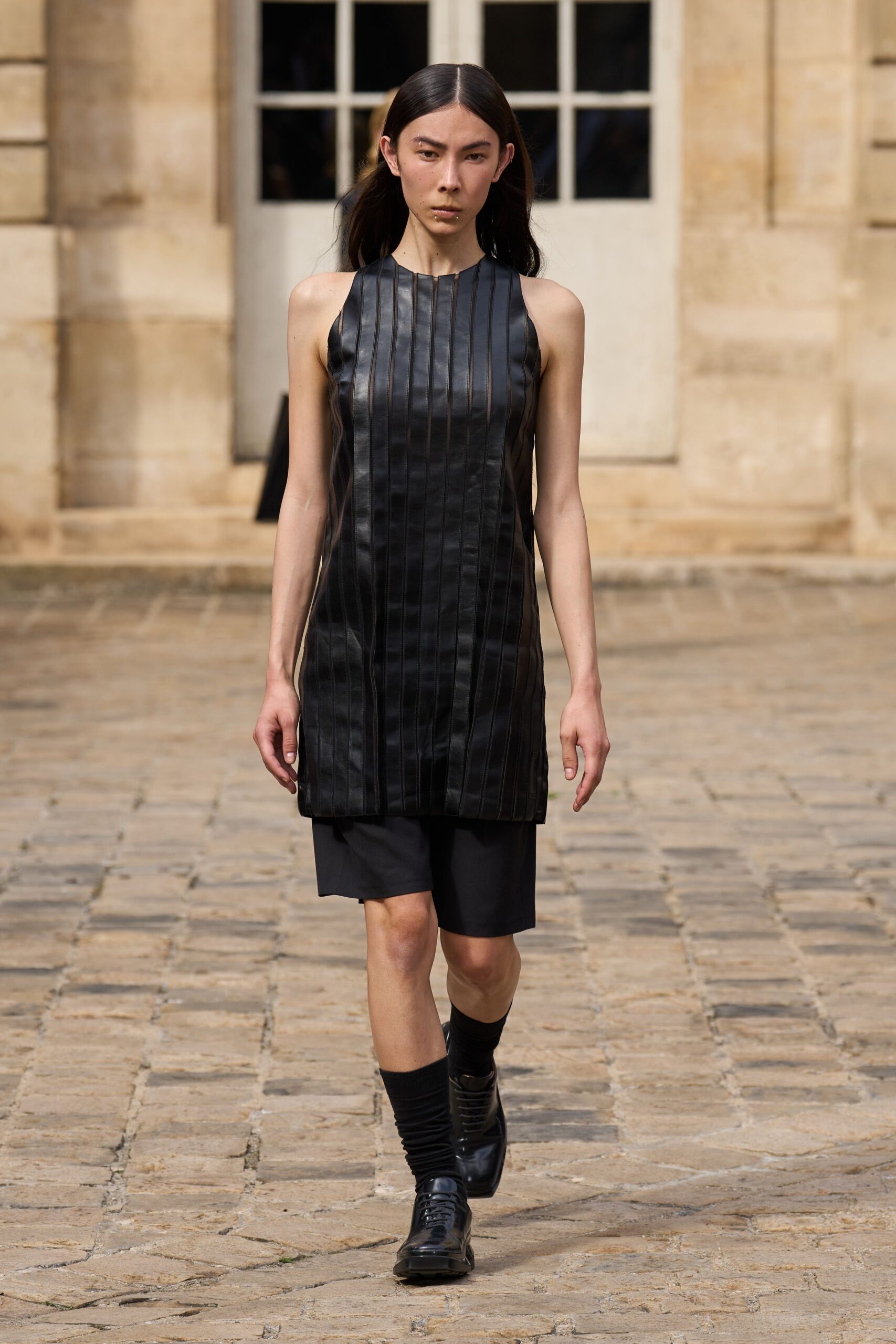 black leather sleeveless high-neck fitted pleated mini dress