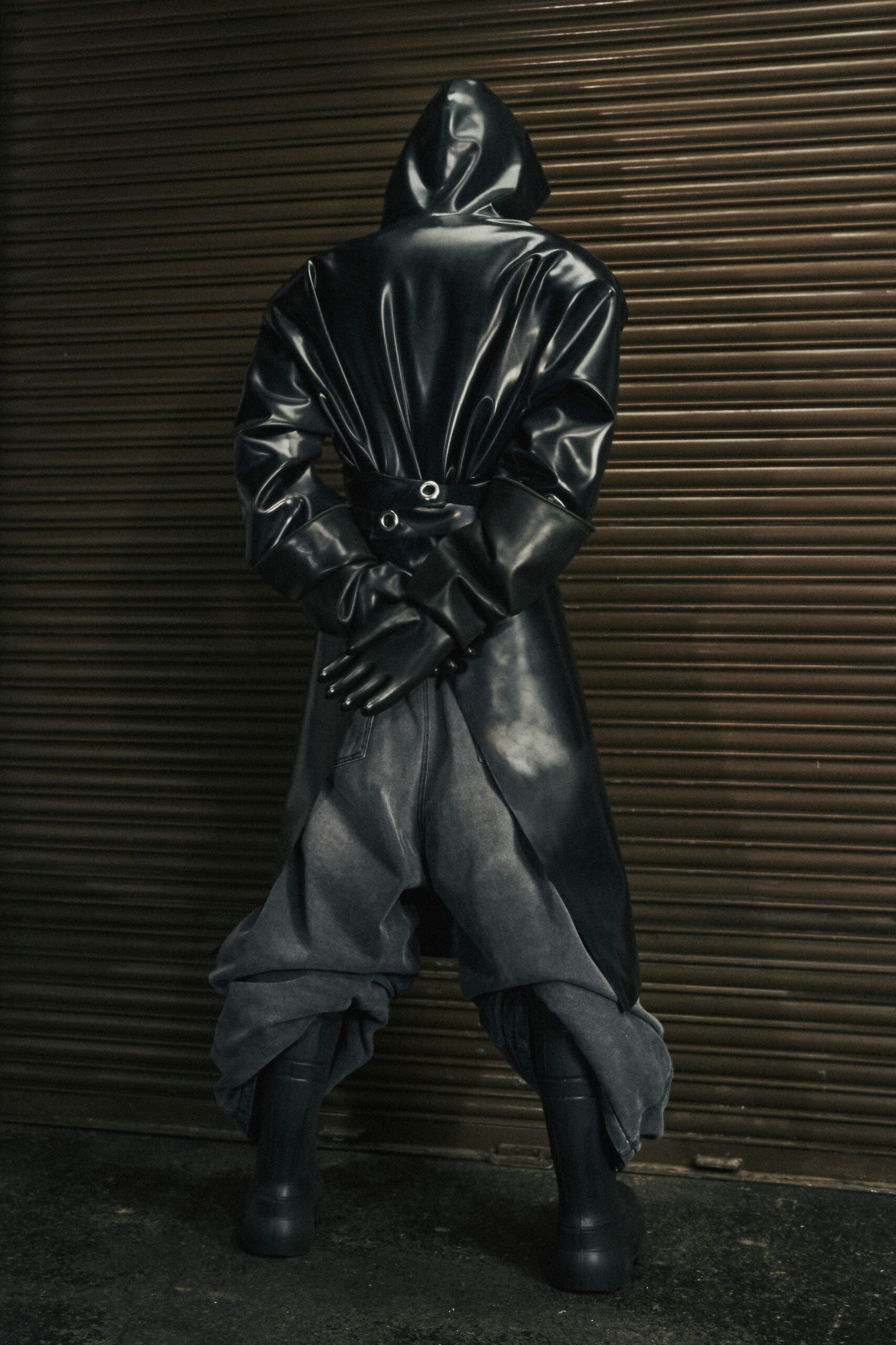 black vinyl coat gray pants