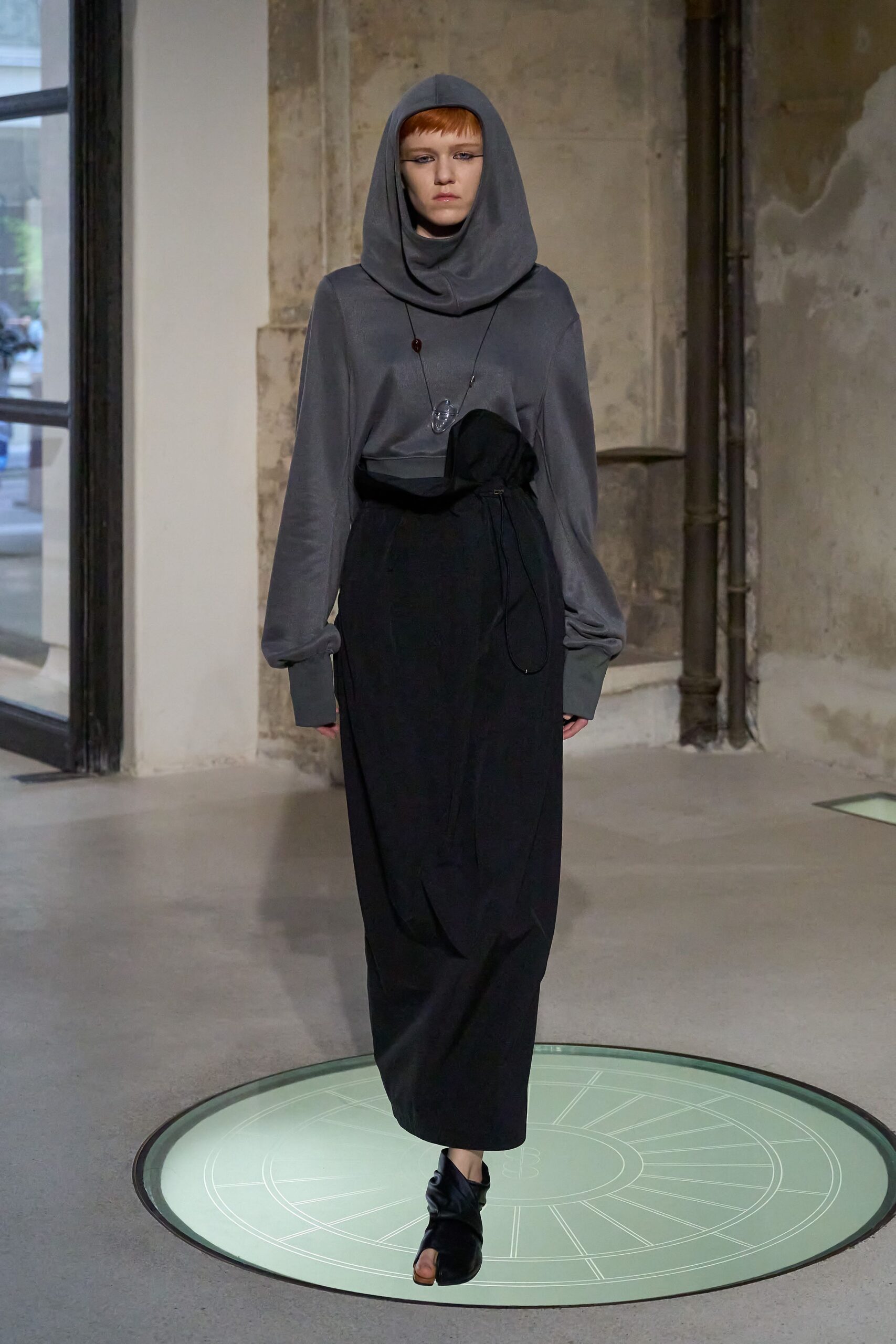 gray hooded top with black skirt