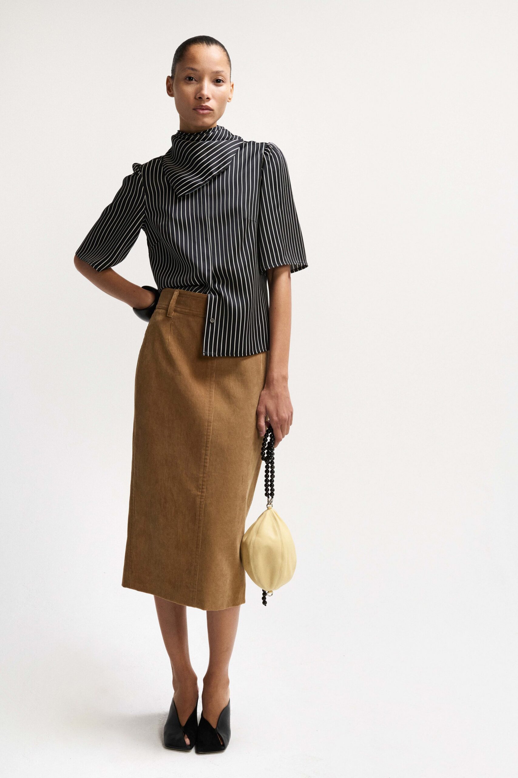 black and white striped top with brown skirt