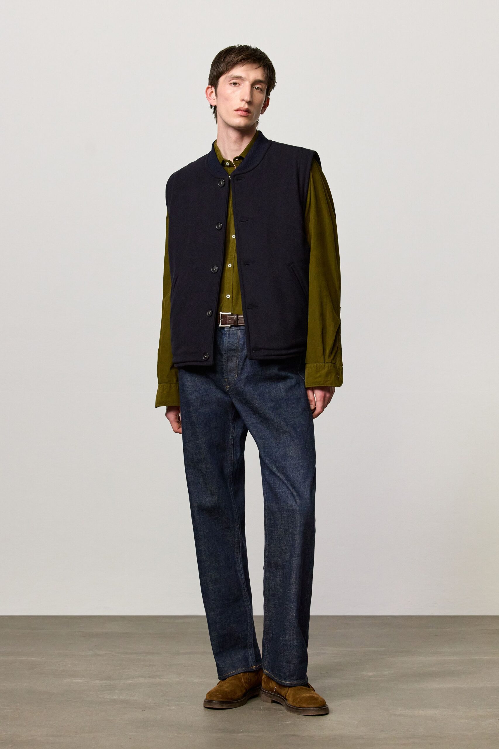 black vest green shirt blue pants