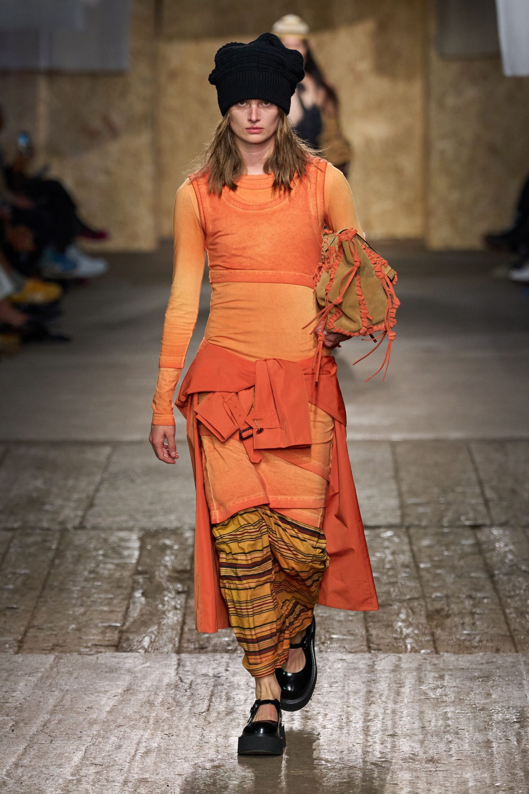 orange layered midi dress with black hat