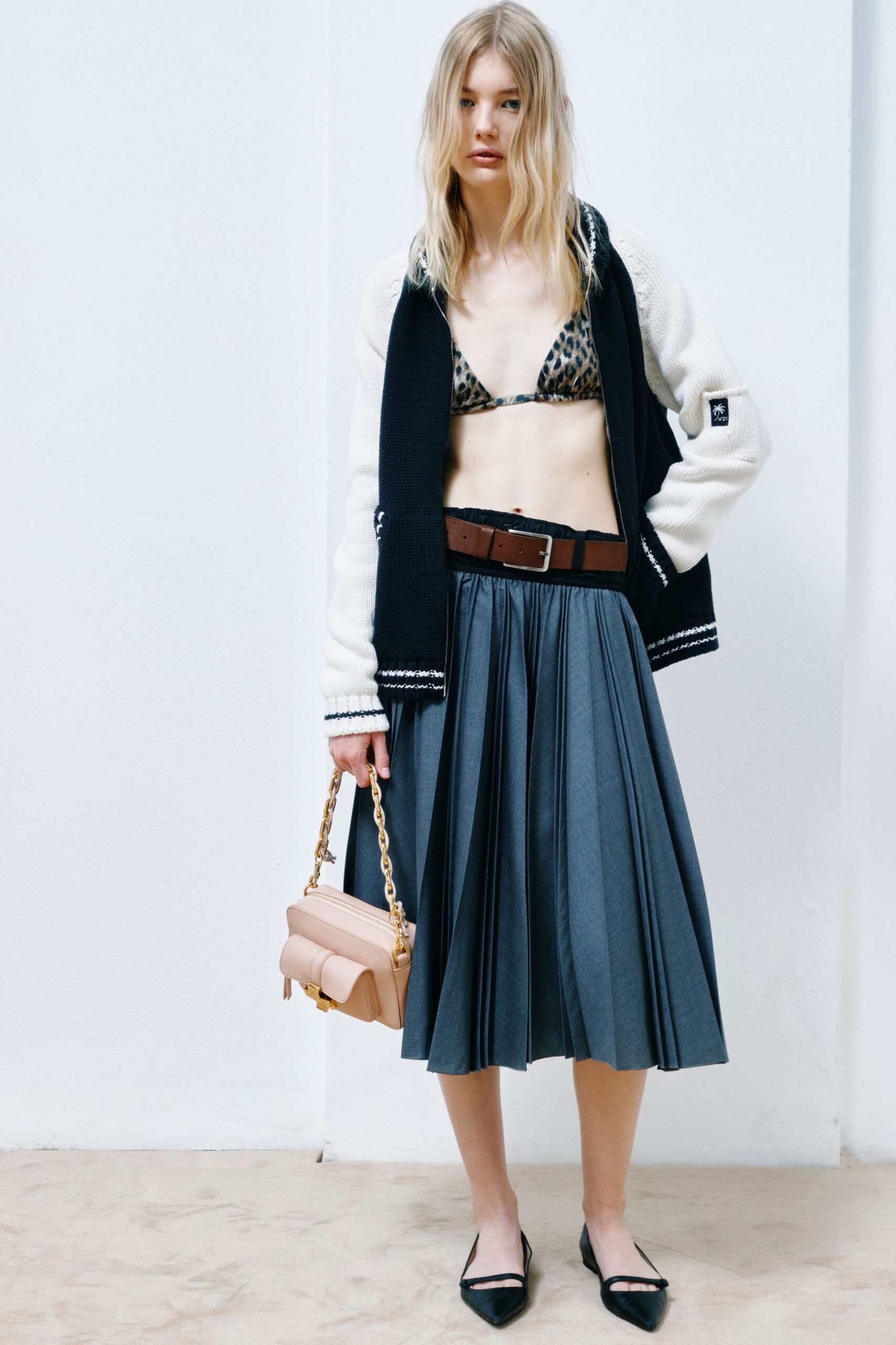 black and white cardigan with gray pleated skirt