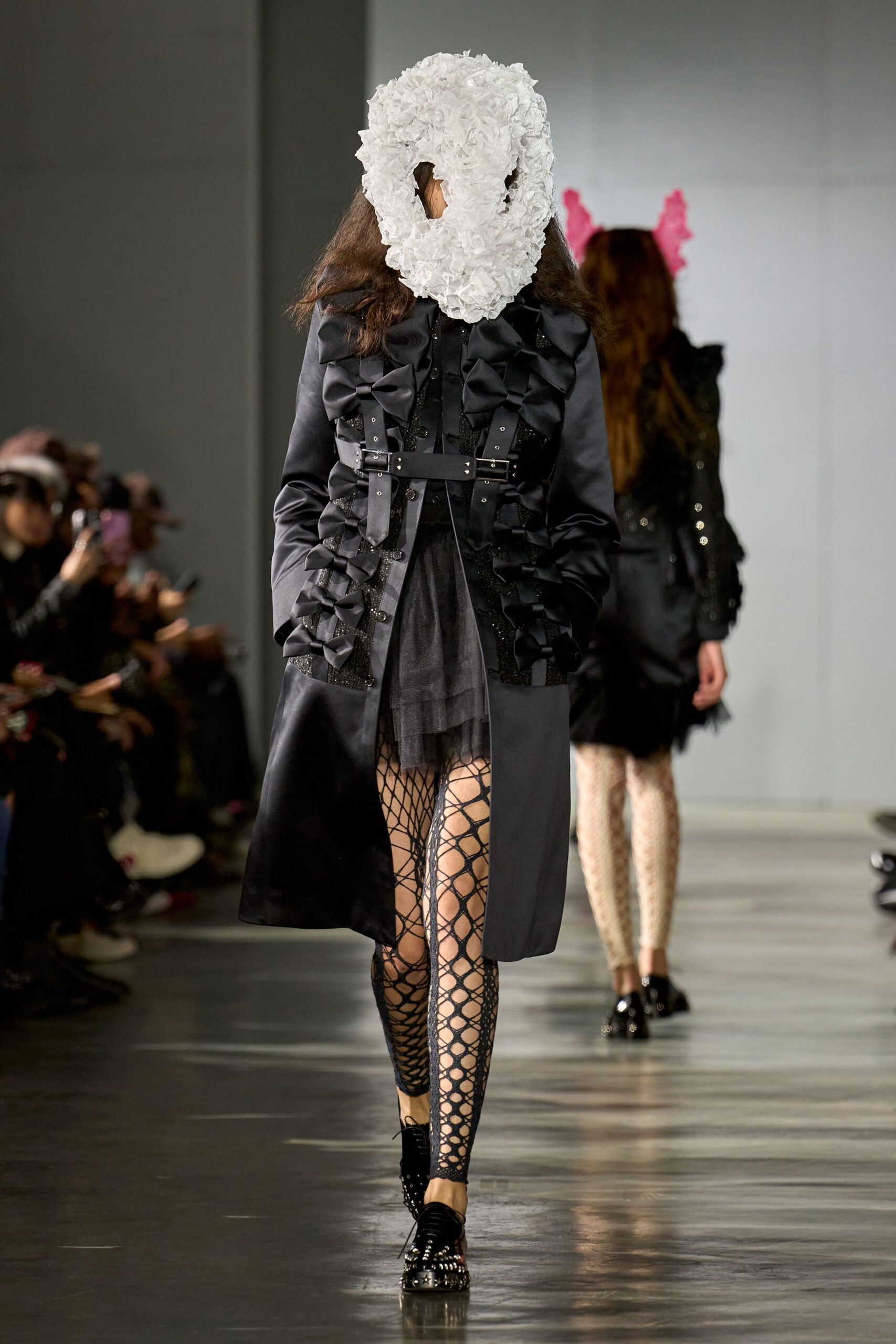 black fitted coat and mini skirt