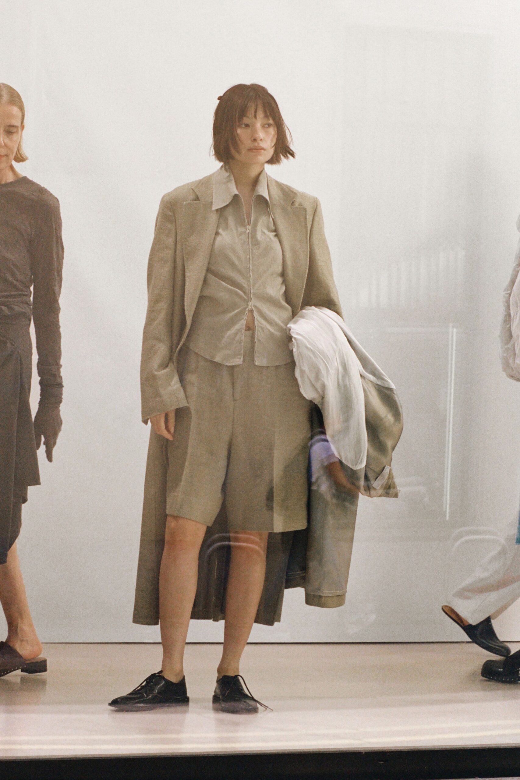 beige relaxed suit with black shoes