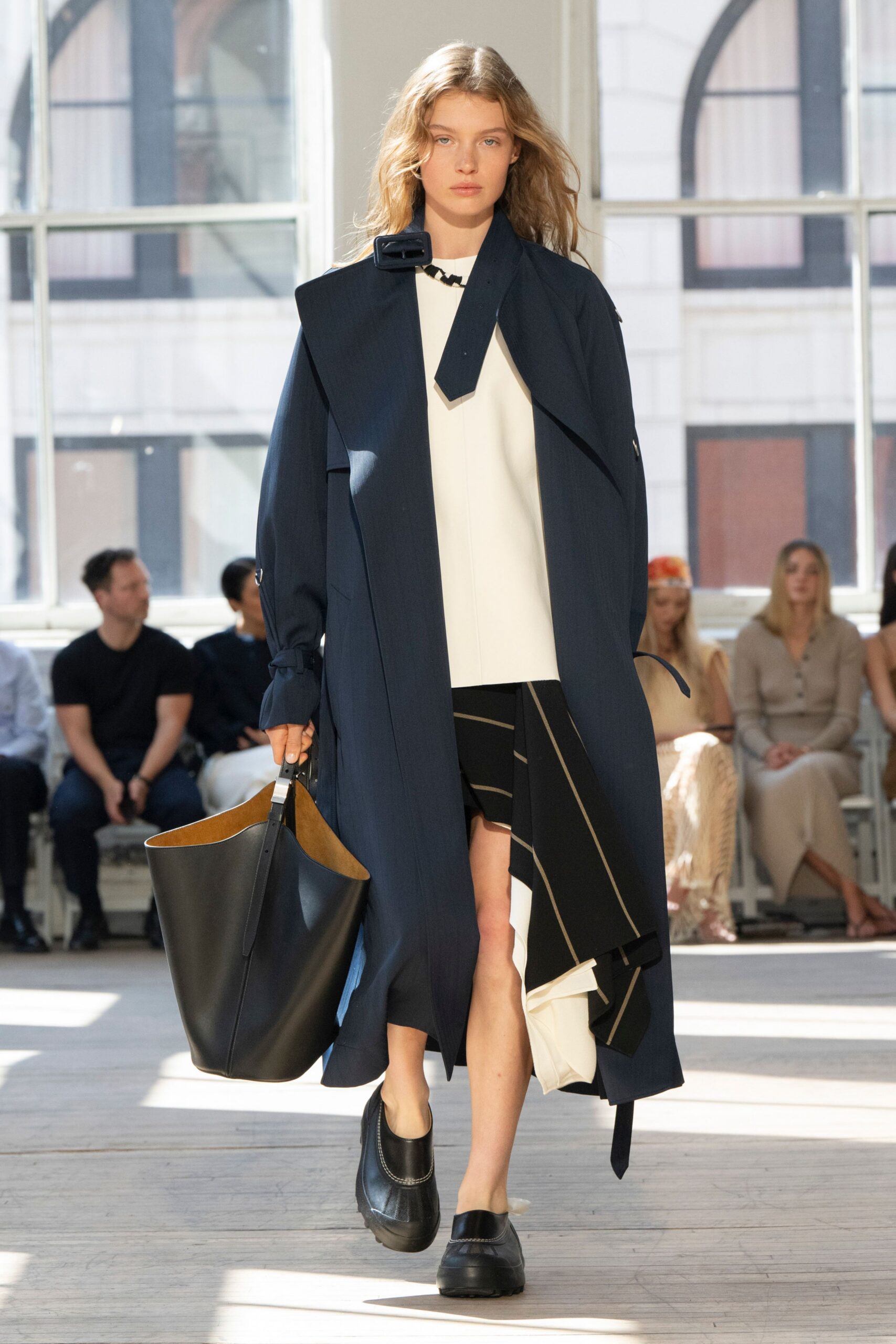 navy coat white top black skirt