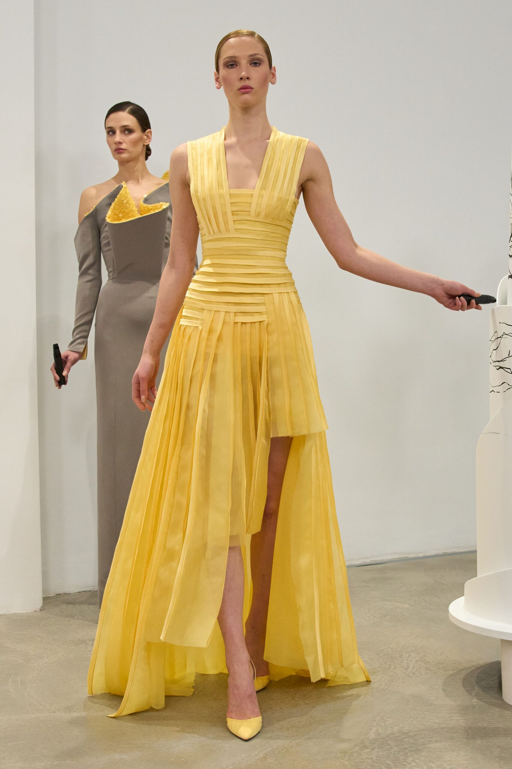 yellow silk sleeveless v-neck fitted pleated flowing gown