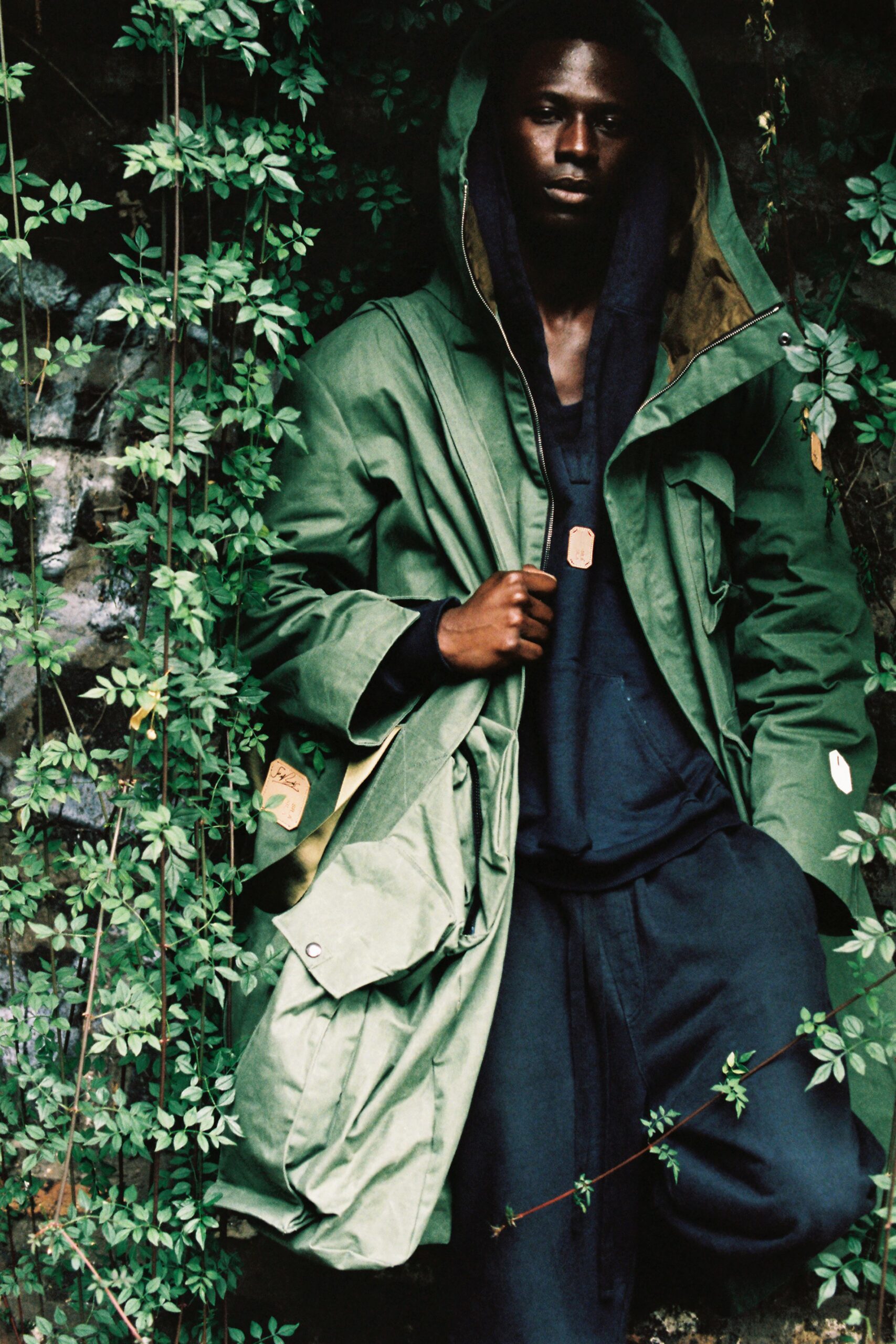 green parka black hoodie black pants