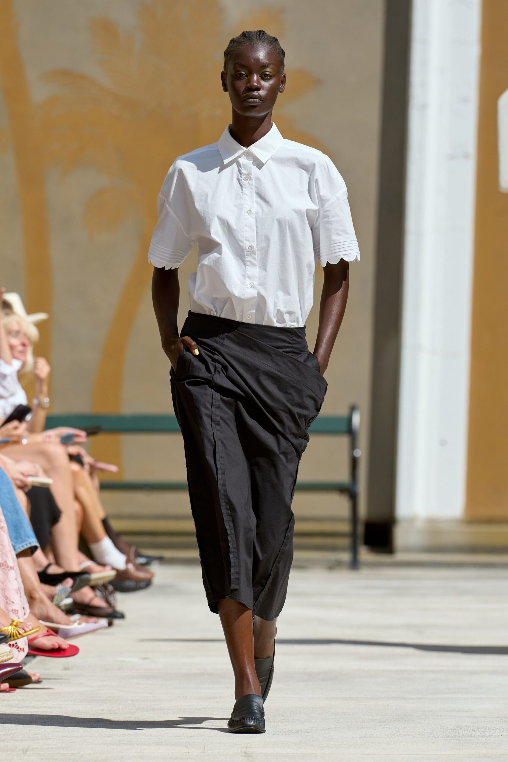 white relaxed shirt black pleated skirt