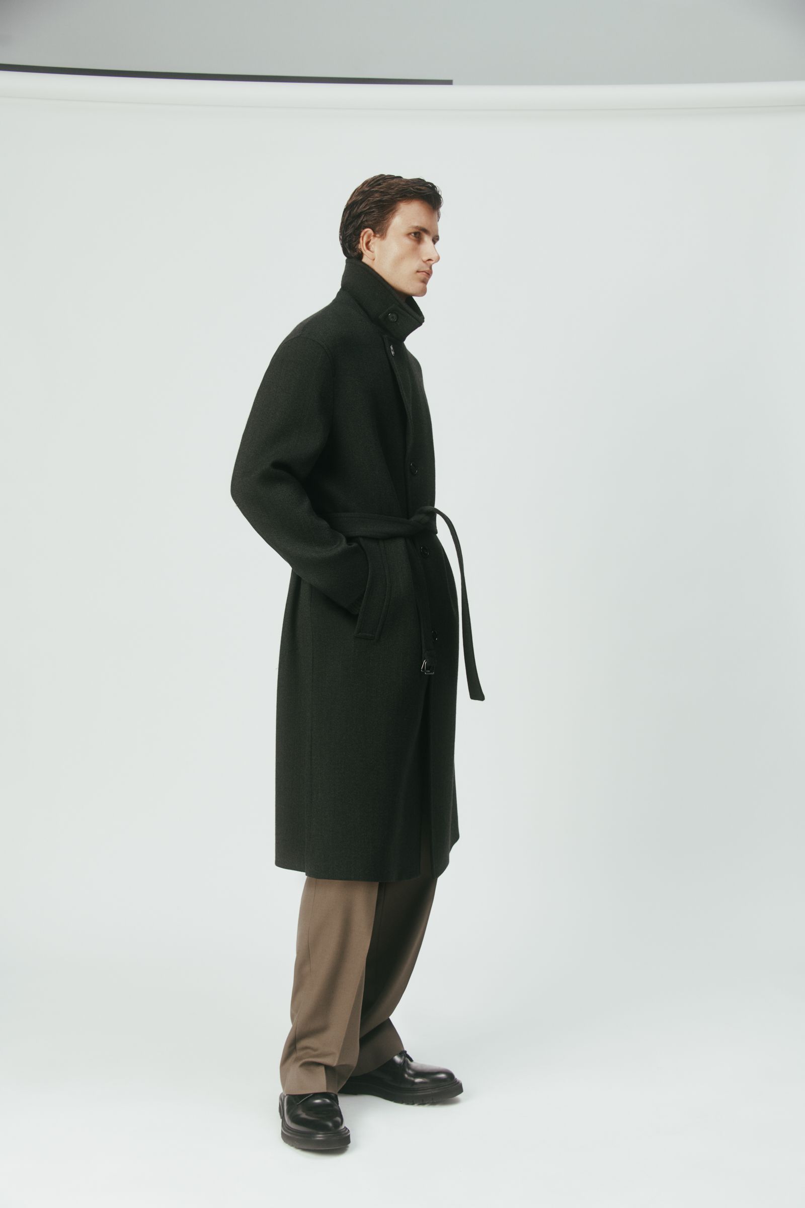 black wool coat with beige pants