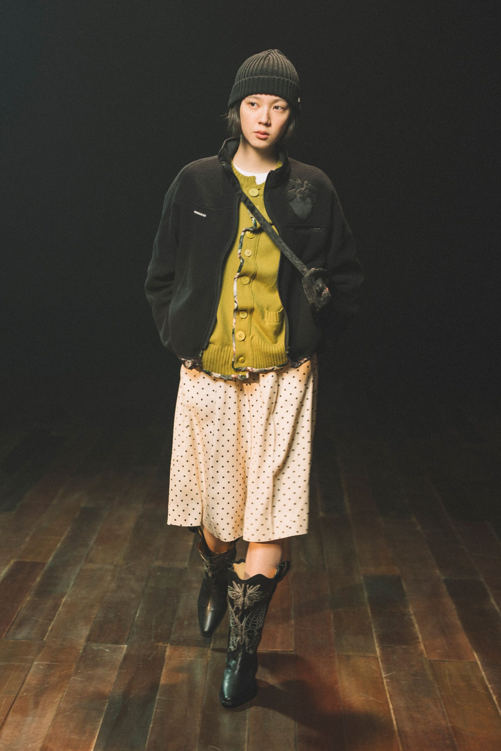 black faux-fur jacket with green cardigan