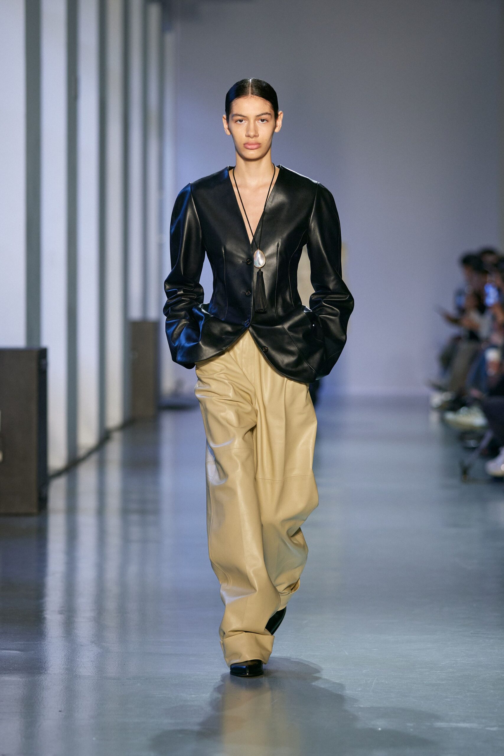 black leather blazer beige pants