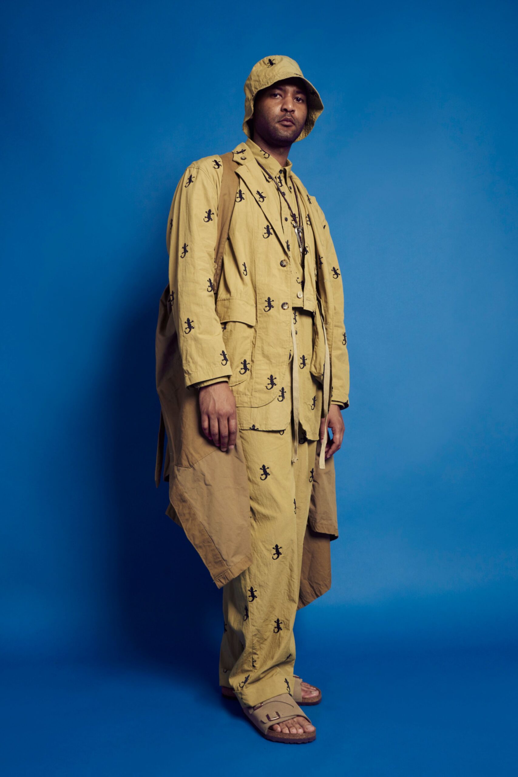 beige cotton long-sleeve collared relaxed buttoned printed coat
