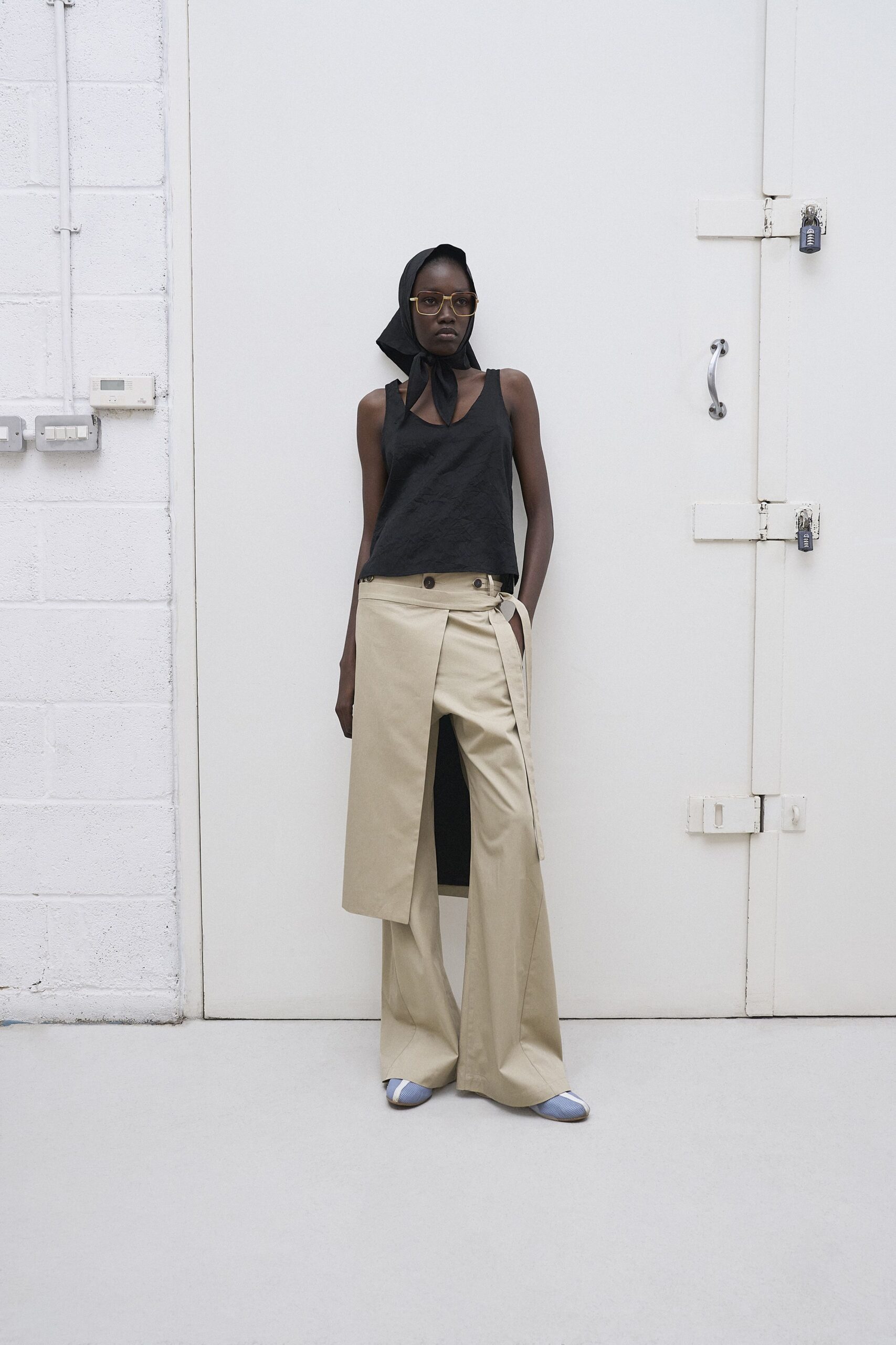 black cotton sleeveless top with beige wide-leg pants