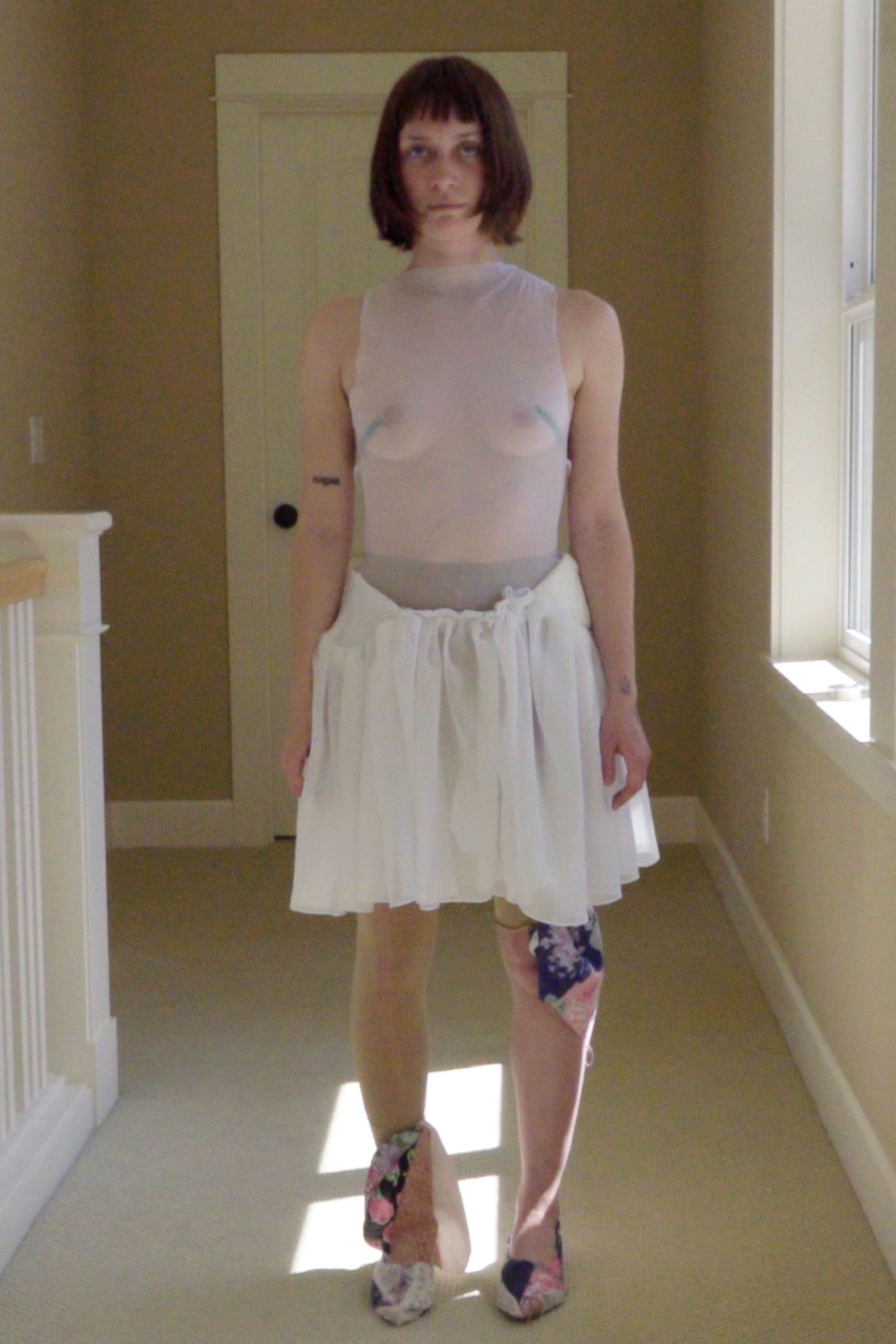 white sheer top and mini skirt