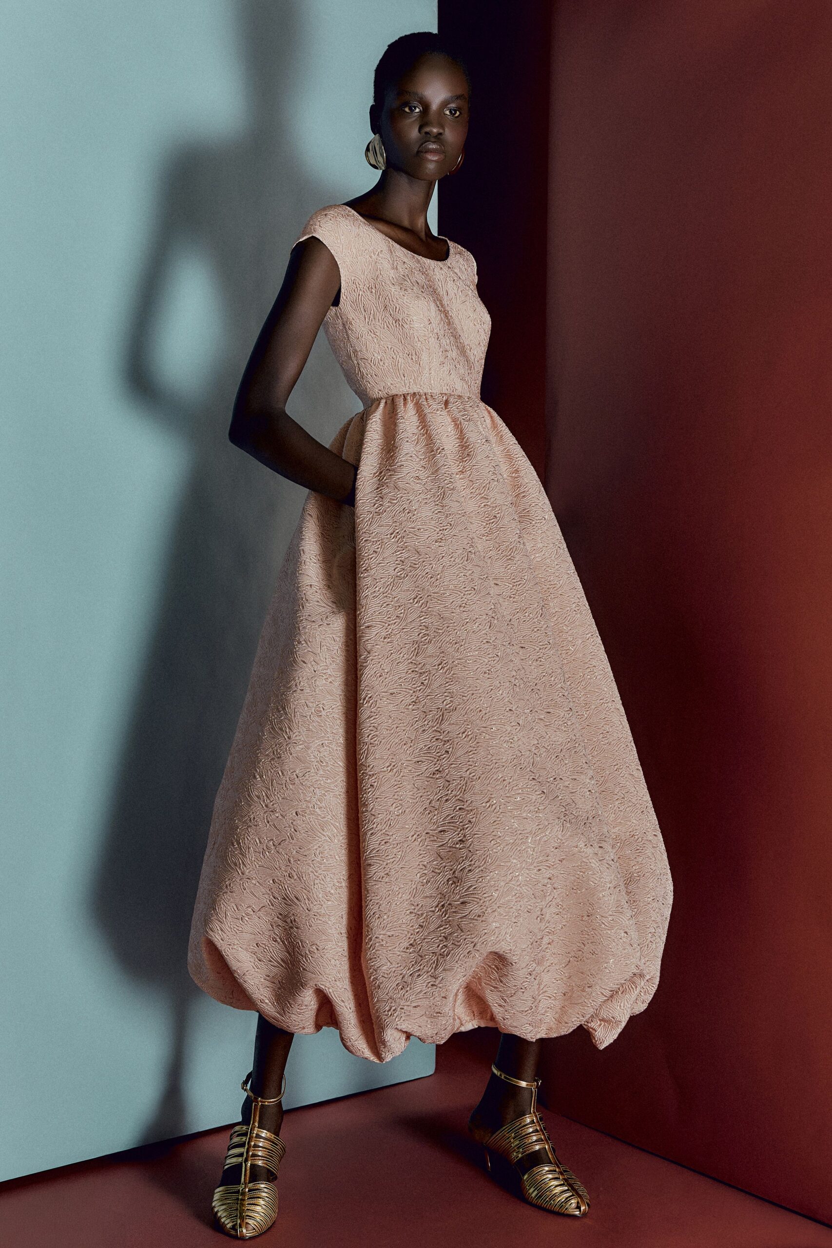 pink pleated maxi dress with gold shoes