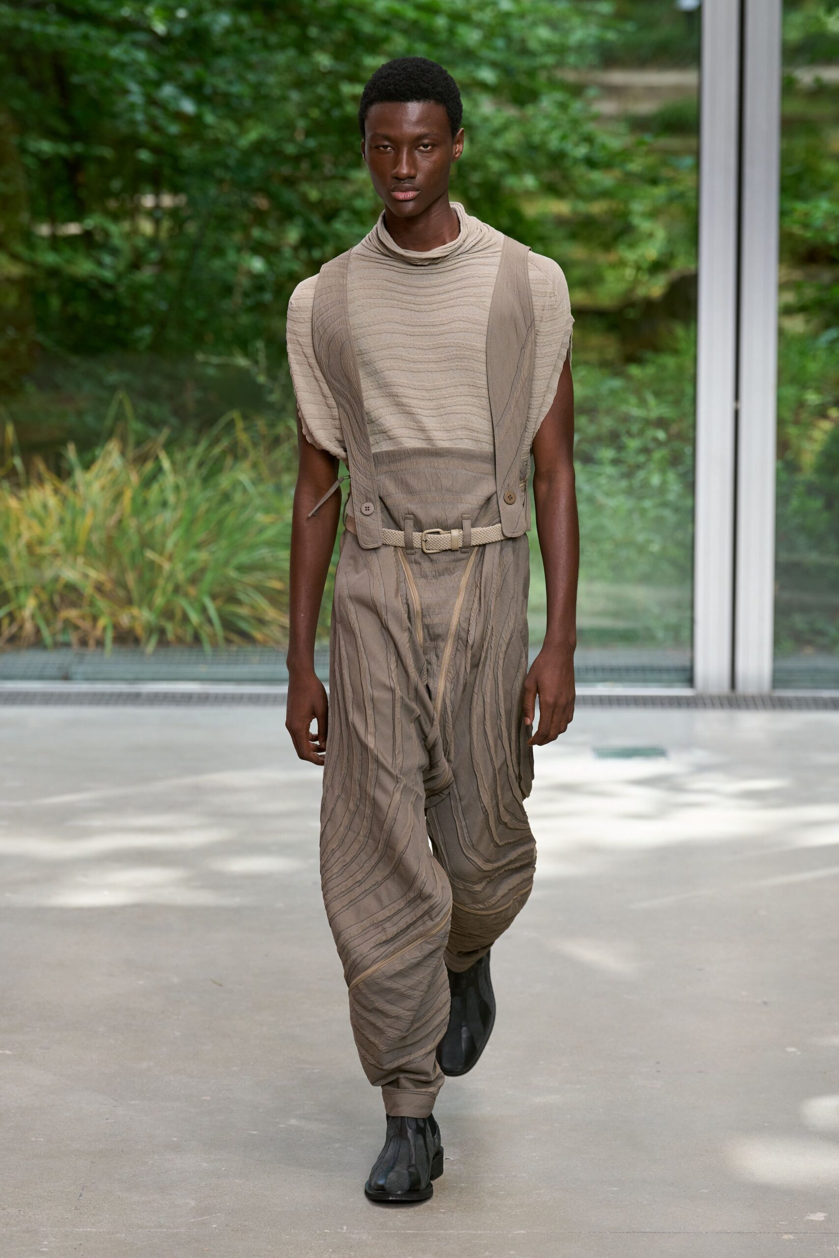 beige pleated jumpsuit with black shoes