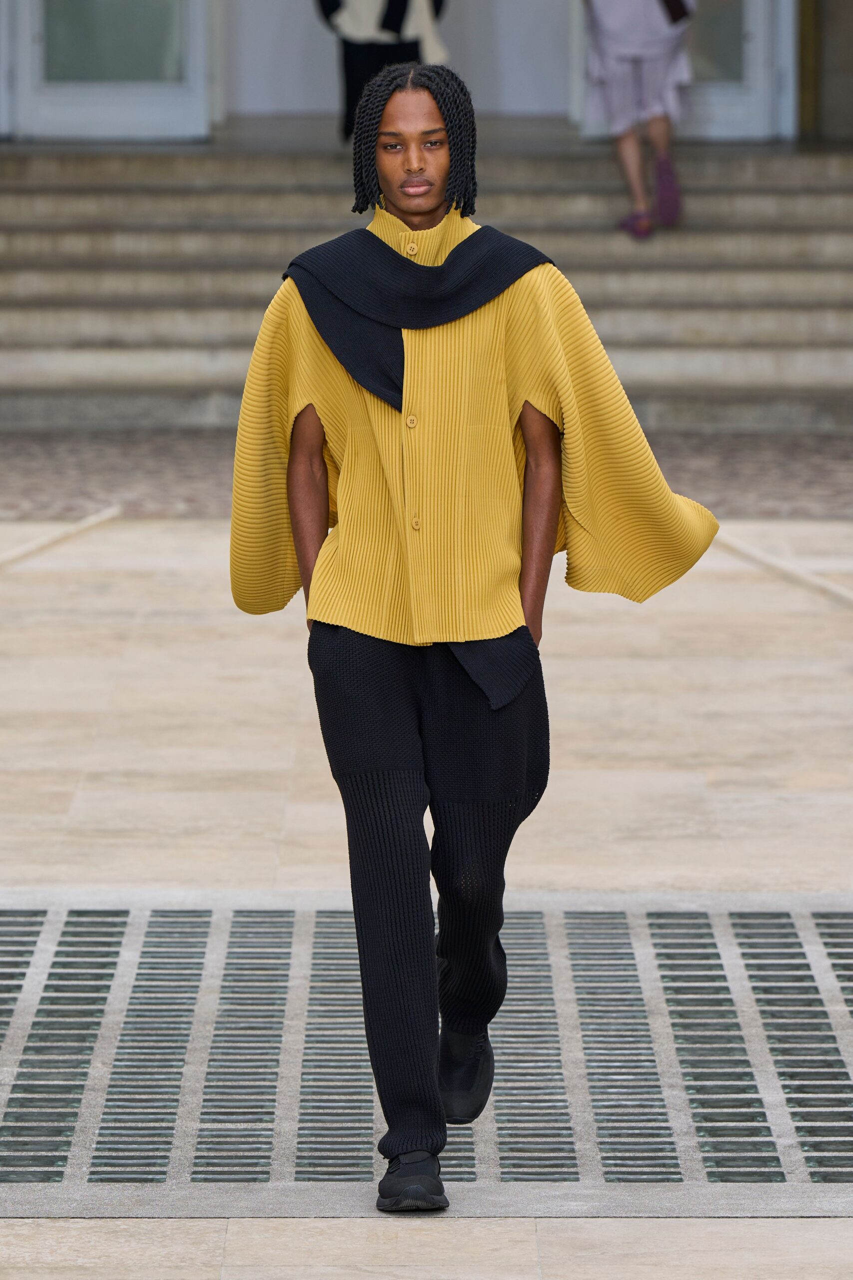 yellow pleated top with black pants